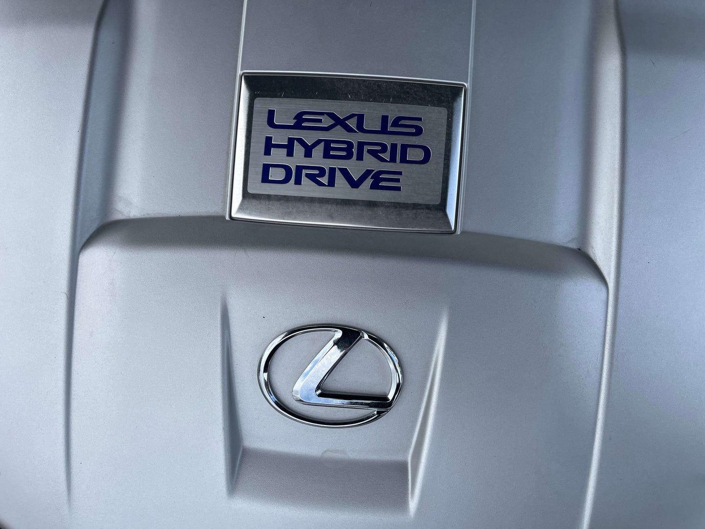 2007 Lexus LS600h AWD V8 5.0L Hybrid Lexus Hybrid Drive logo on the engine cover of a hybrid vehicle, representing efficiency and innovation in automotive technology.