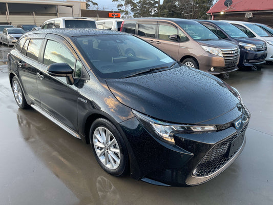 2019 Toyota Corolla Touring 1.8 Hybrid S Station Wagon in black with raindrops on the surface.