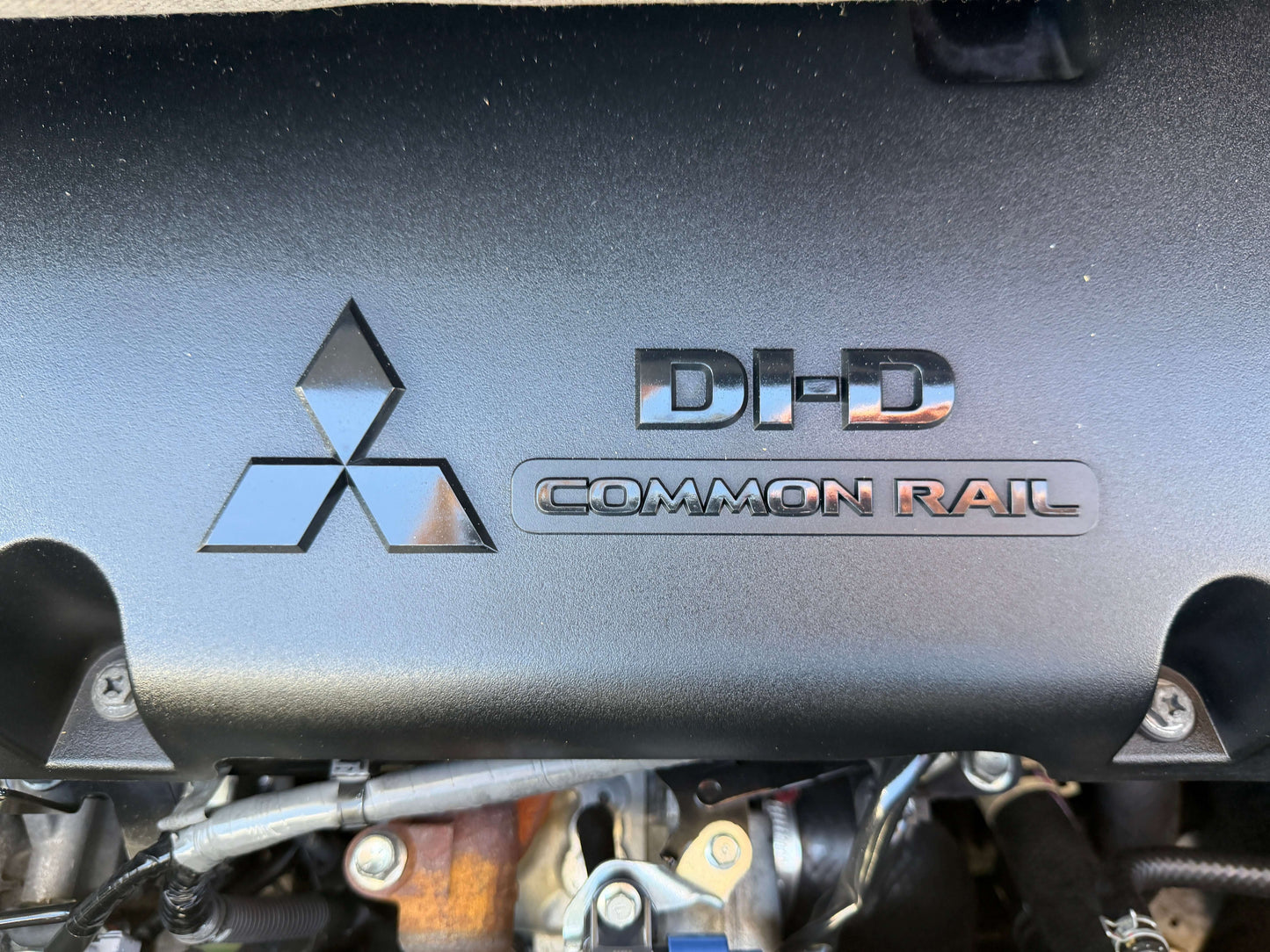 Mitsubishi DH-D Common Rail engine cover showing logo for 2015 Mitsubishi Delica D5 2.3 Diesel-Turbo 4WD.
