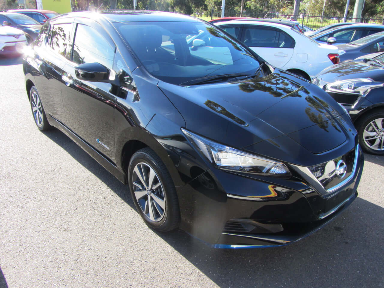 2019 Nissan Leaf e+ 62kW X-Edition Full Electric parked in a parking lot, showcasing its sleek black exterior.