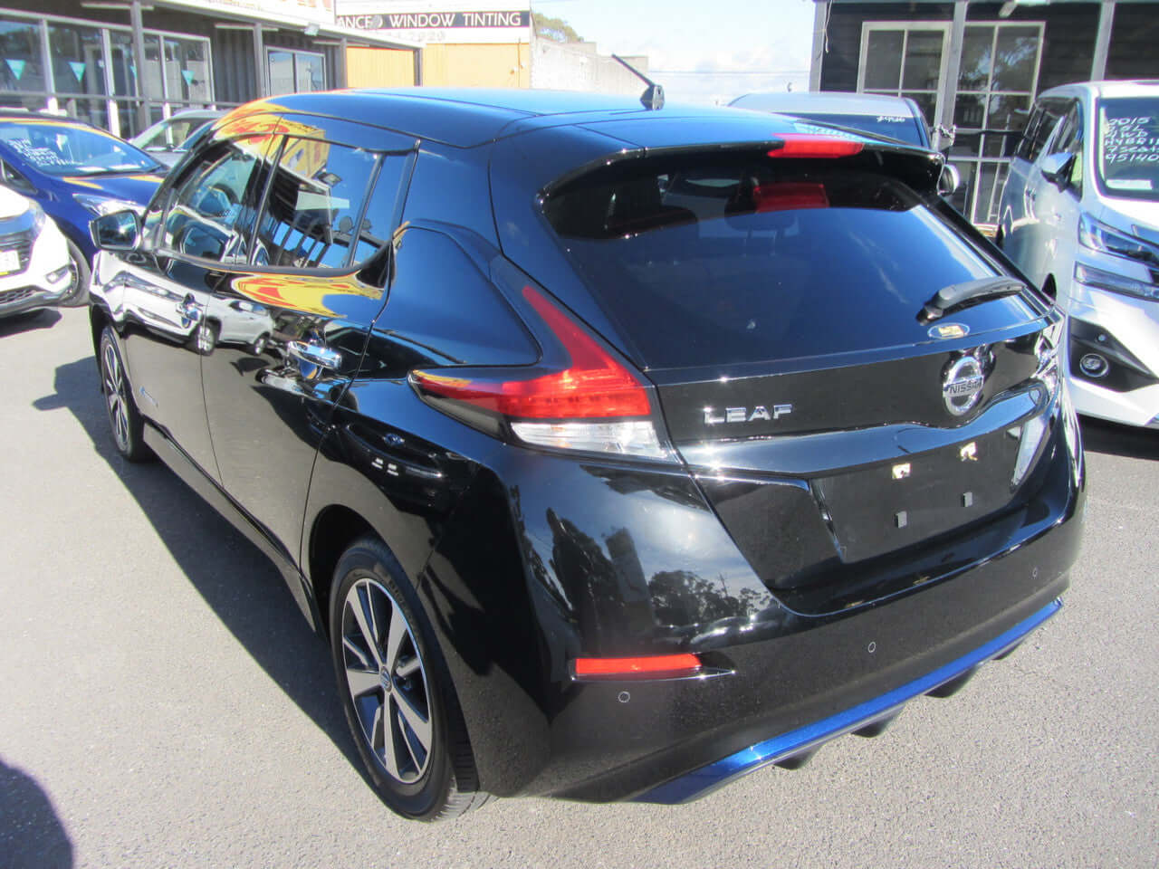 2019 Nissan Leaf e+ 62kW X-Edition Full Electric parked, showing rear view and sleek design in black color.