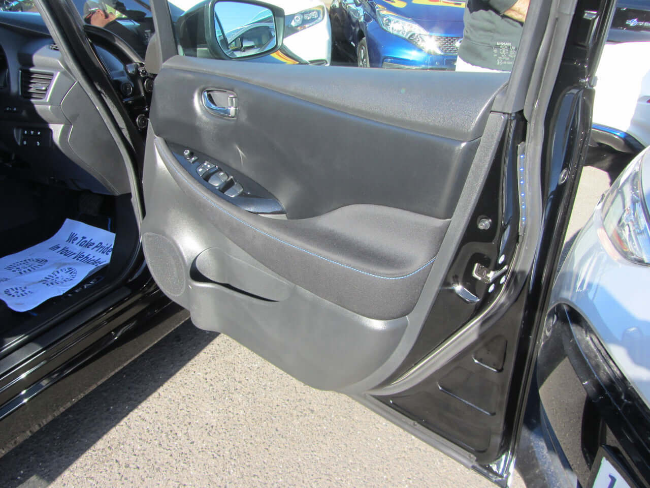 Interior view of the 2019 Nissan Leaf e+ 62kW X-Edition Full Electric door panel with controls.