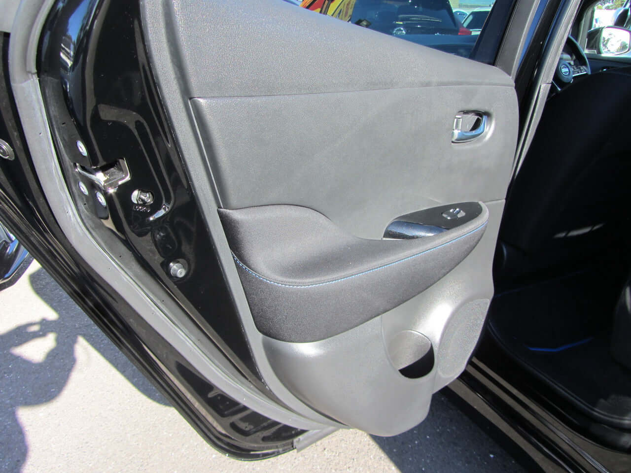 Interior door panel of a 2019 Nissan Leaf e+ 62kW X-Edition Full Electric, showcasing modern design and features.