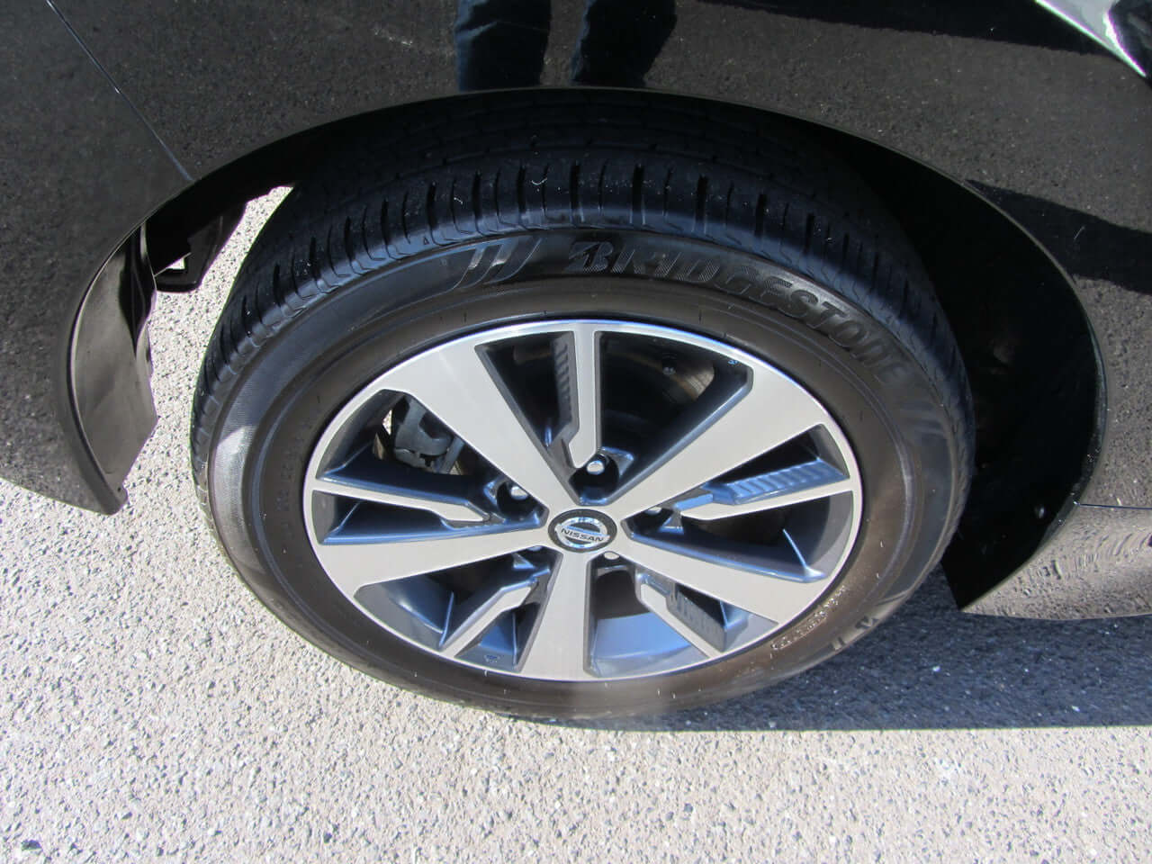 Close-up of the wheel of a 2019 Nissan Leaf e+ 62kW X-Edition Full Electric, showcasing sleek design and quality tires.