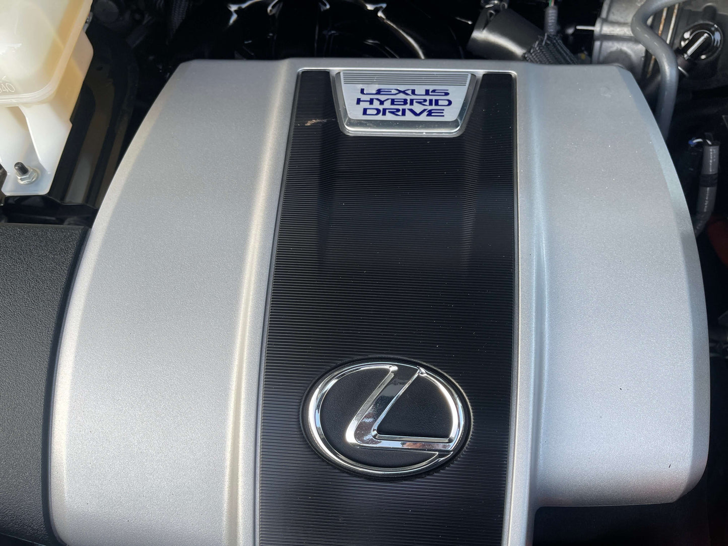2020 Lexus RX450H V6 3.5L Hybrid engine cover with Lexus Hybrid Drive logo and emblem.