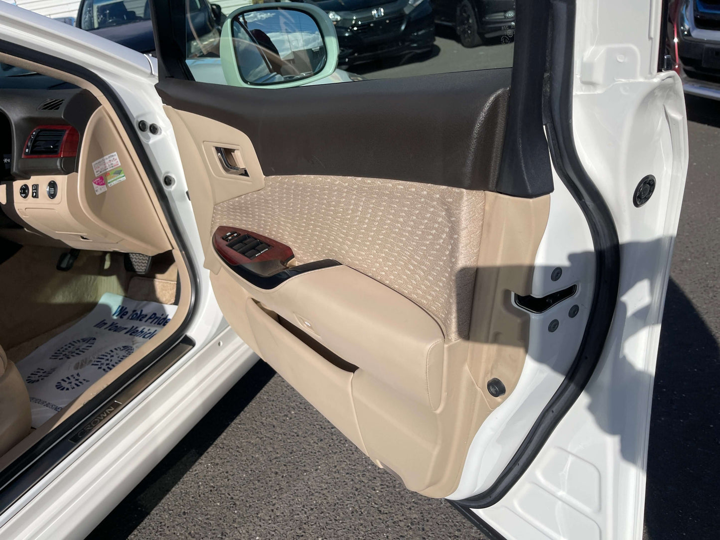 Interior view of the 2008 Toyota Crown V6 3.0L Royal Saloon Luxury Sedan door panel featuring premium materials.