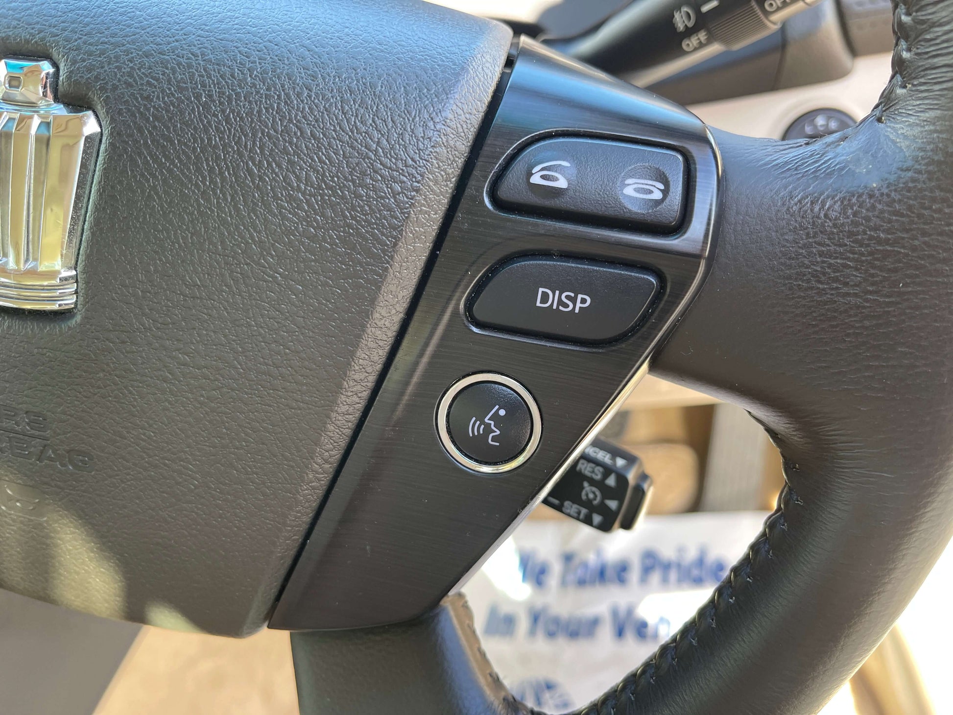 Close-up of the steering wheel controls of a 2008 Toyota Crown V6 3.0L Royal Saloon Luxury Sedan.