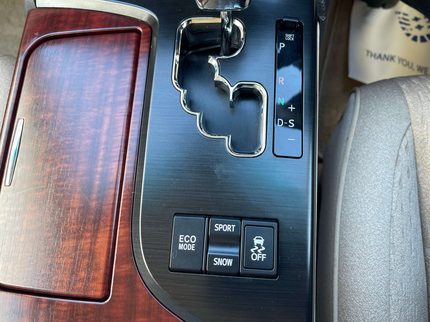 Interior view of the 2008 Toyota Crown V6 3.0L gear shift with drive mode buttons including Eco, Sport, and Snow.