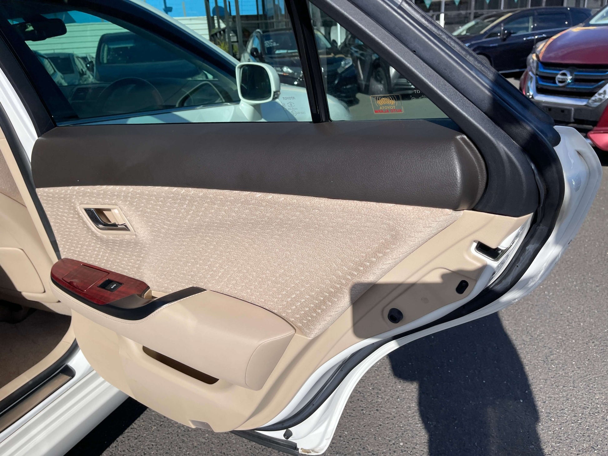 Interior view of the door panel of a 2008 Toyota Crown V6 3.0L Royal Saloon Luxury Sedan showing beige upholstery.