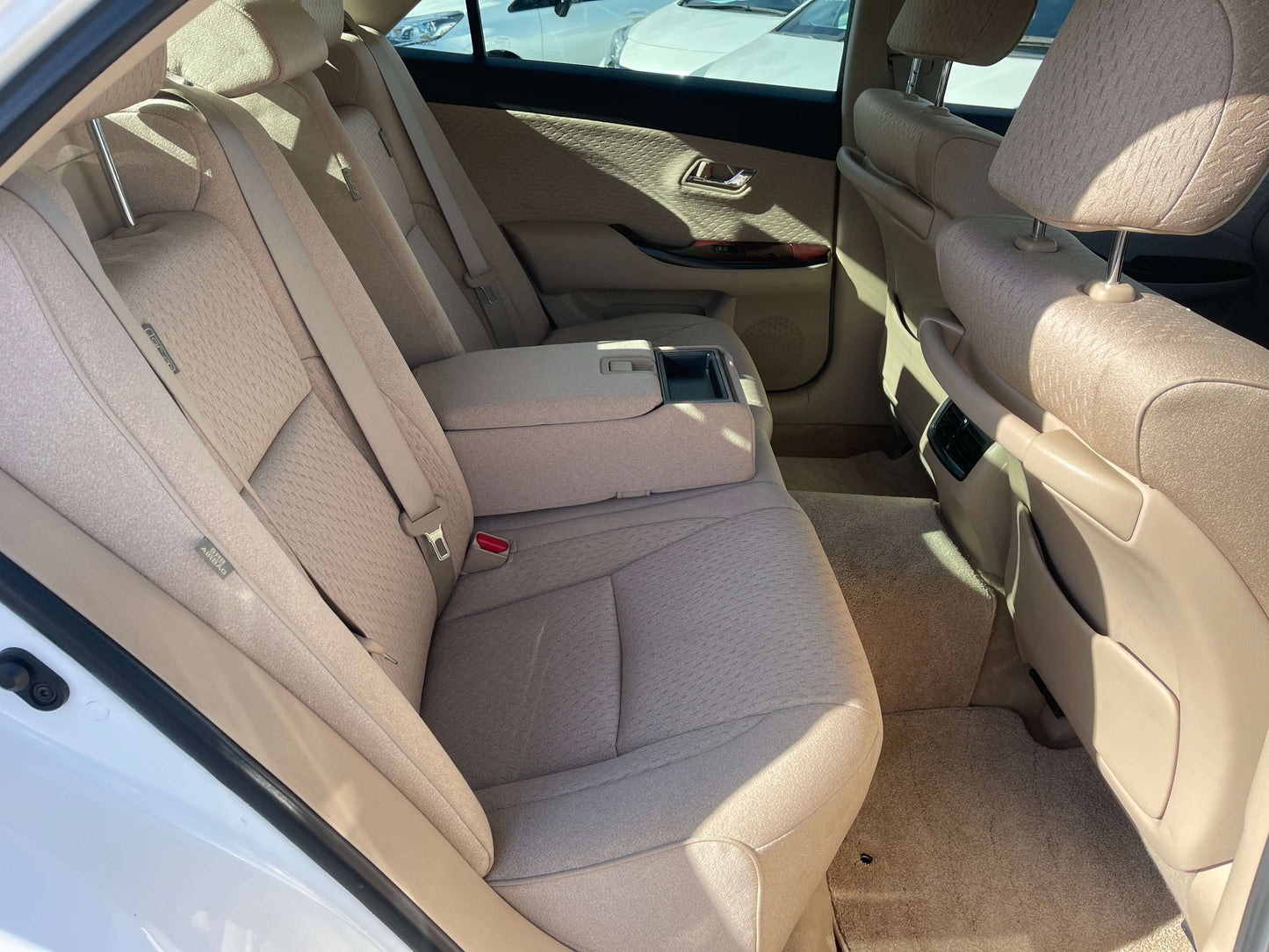 Interior view of the back seat of a 2008 Toyota Crown V6 3.0L Royal Saloon Luxury Sedan, highlighting spacious seating.