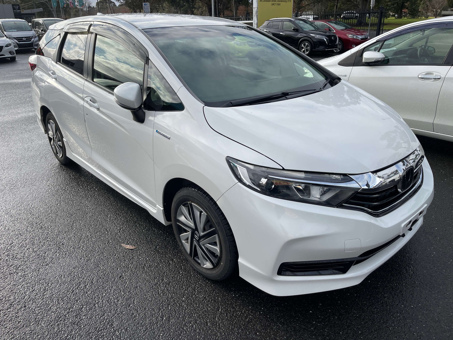 2021 Honda Shuttle Hybrid X Honda Sensing Edition 5 seater in white color parked in a lot.