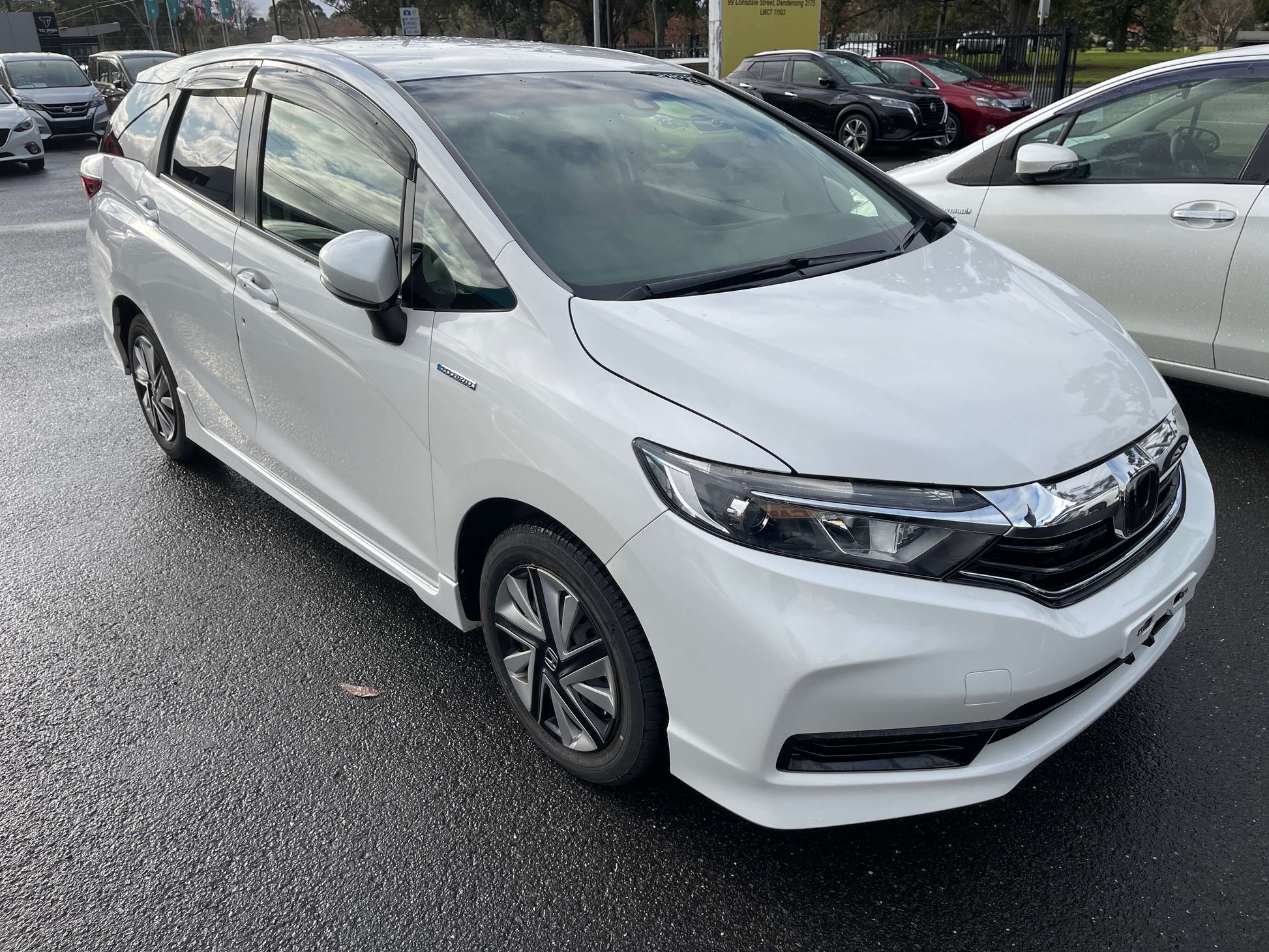 2021 Honda Shuttle Hybrid X Honda Sensing Edition 5 seater in white color parked in a lot.