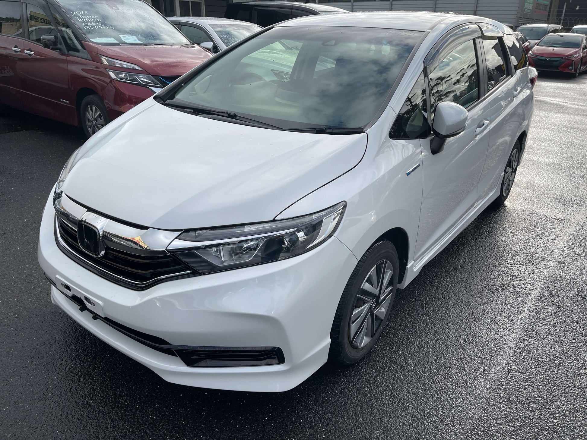 2021 Honda Shuttle Hybrid X Honda Sensing Edition 5 seater in white color, front view, parked outdoors.