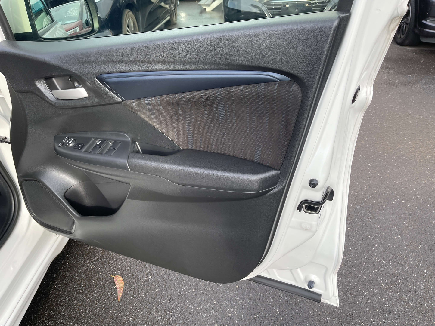 Interior view of the 2021 Honda Shuttle Hybrid door with ergonomic design and controls for the 5 seater.