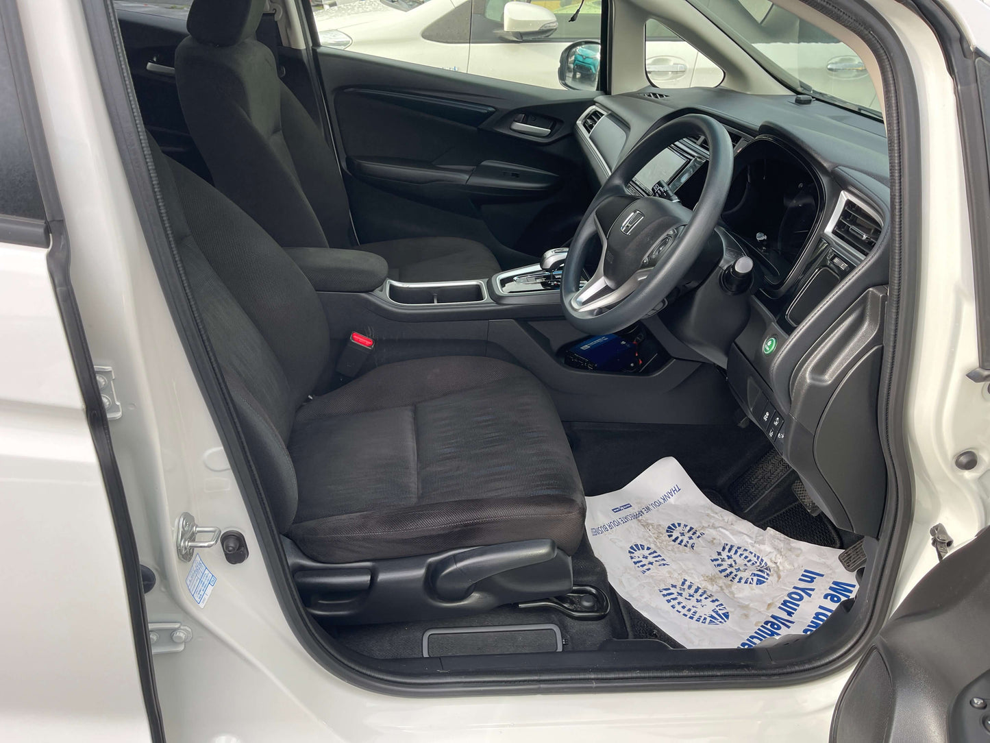 2021 Honda Shuttle Hybrid interior view showing driver seat and dashboard, 5 seater, modern design features.