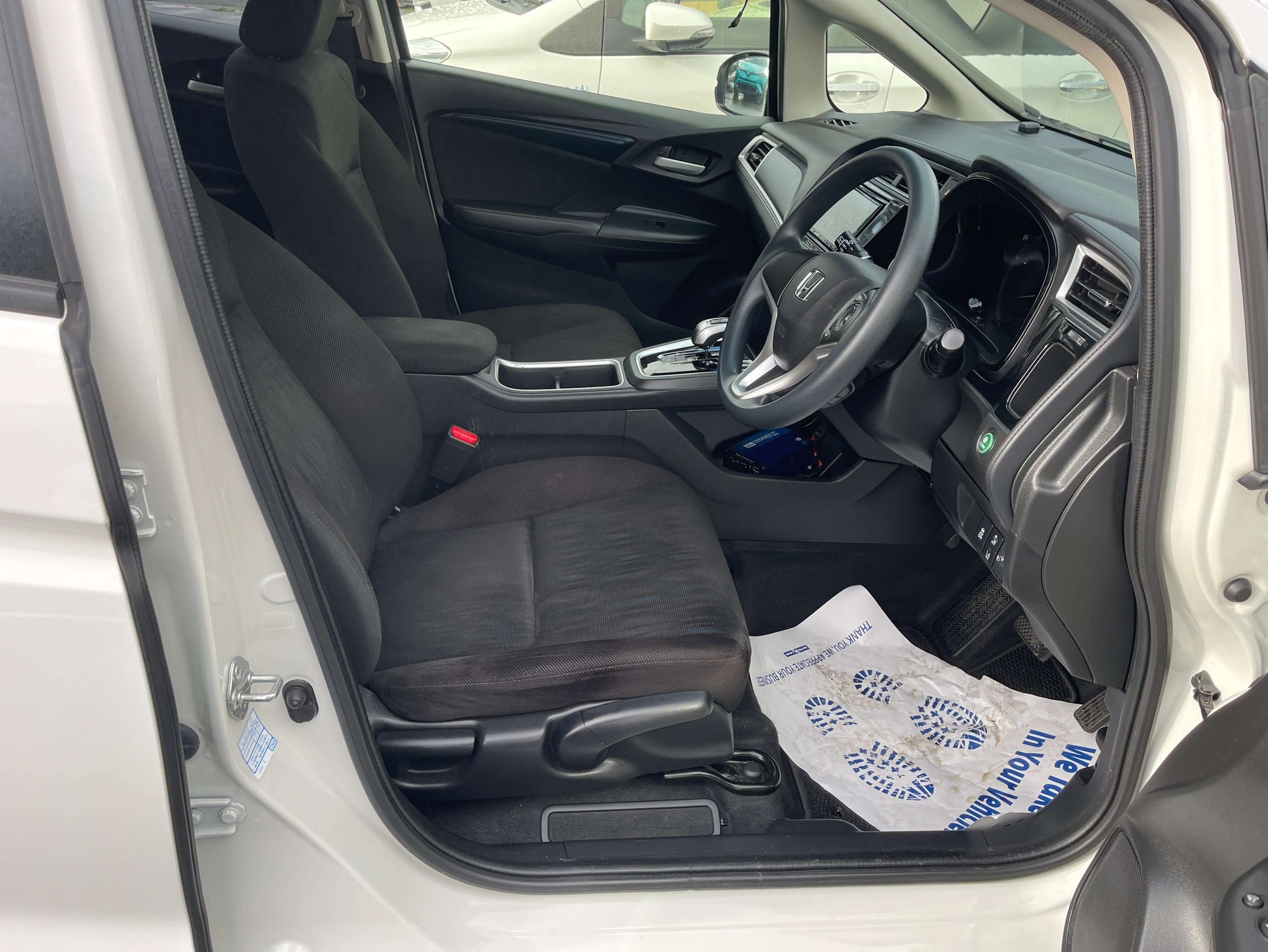 2021 Honda Shuttle Hybrid interior view showing driver seat and dashboard, 5 seater, modern design features.