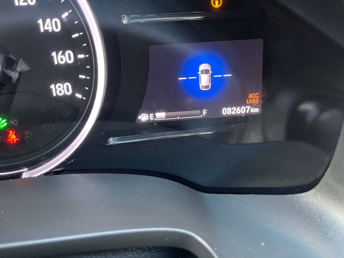 Dashboard display of the 2021 Honda Shuttle Hybrid showing mileage of 82607 km and parking assist feature.