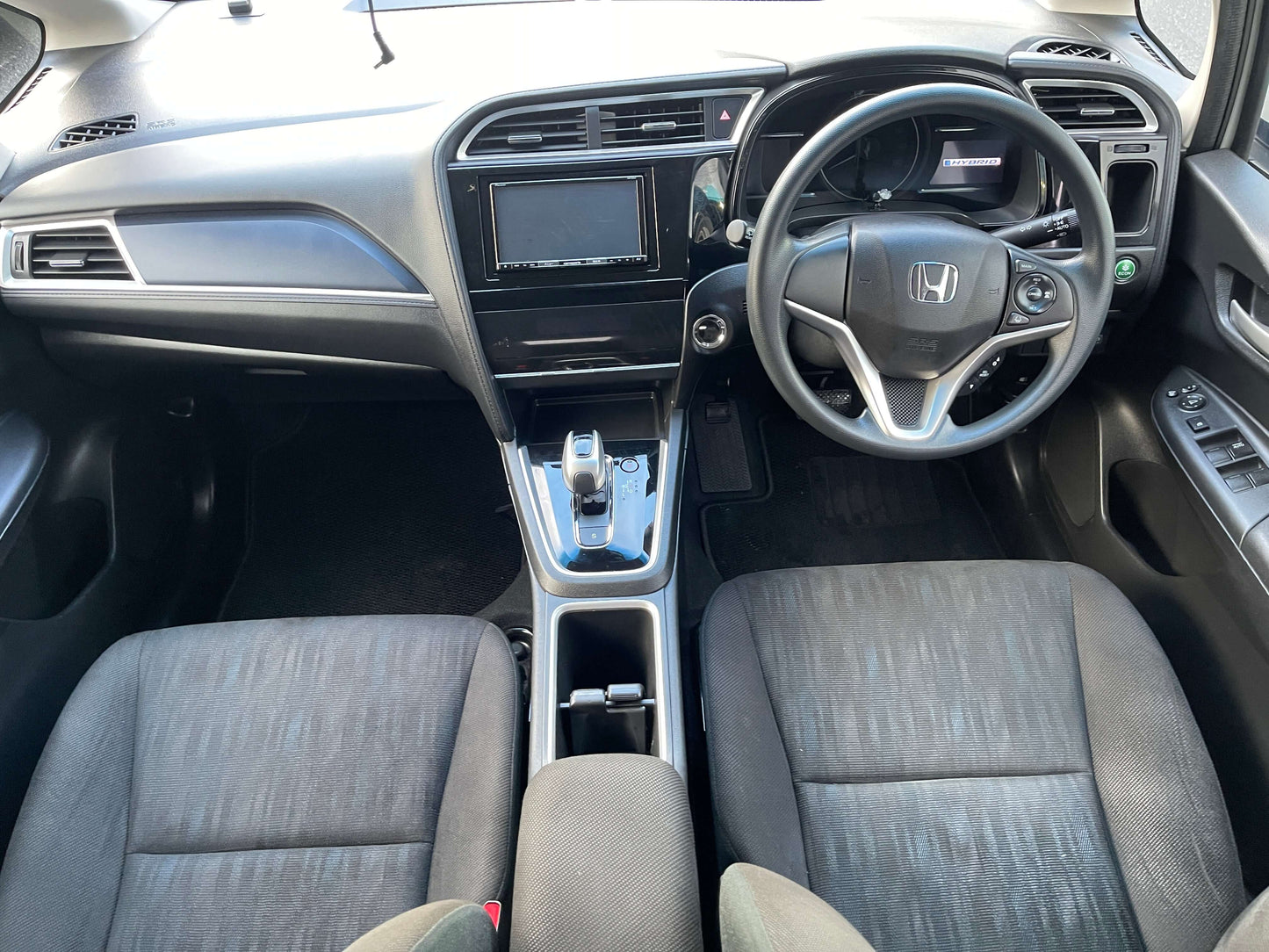 Interior view of 2021 Honda Shuttle Hybrid X Honda Sensing Edition showcasing dashboard and seating.
