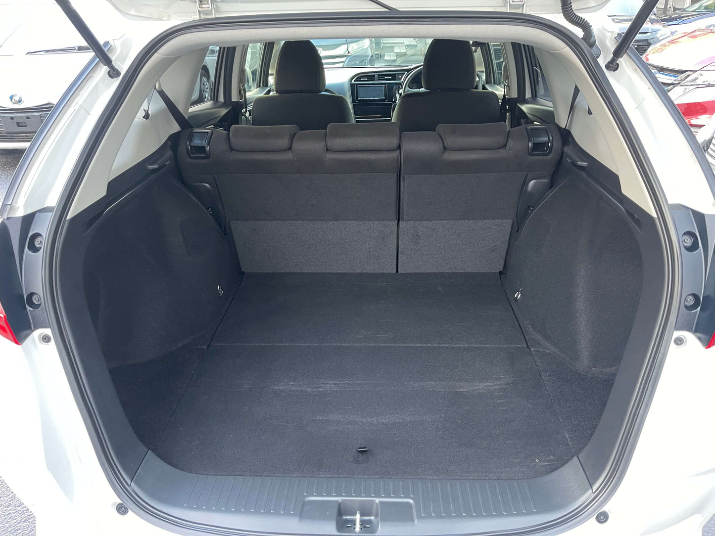 Interior view of 2021 Honda Shuttle Hybrid X Honda Sensing Edition trunk space, showcasing spacious cargo area.