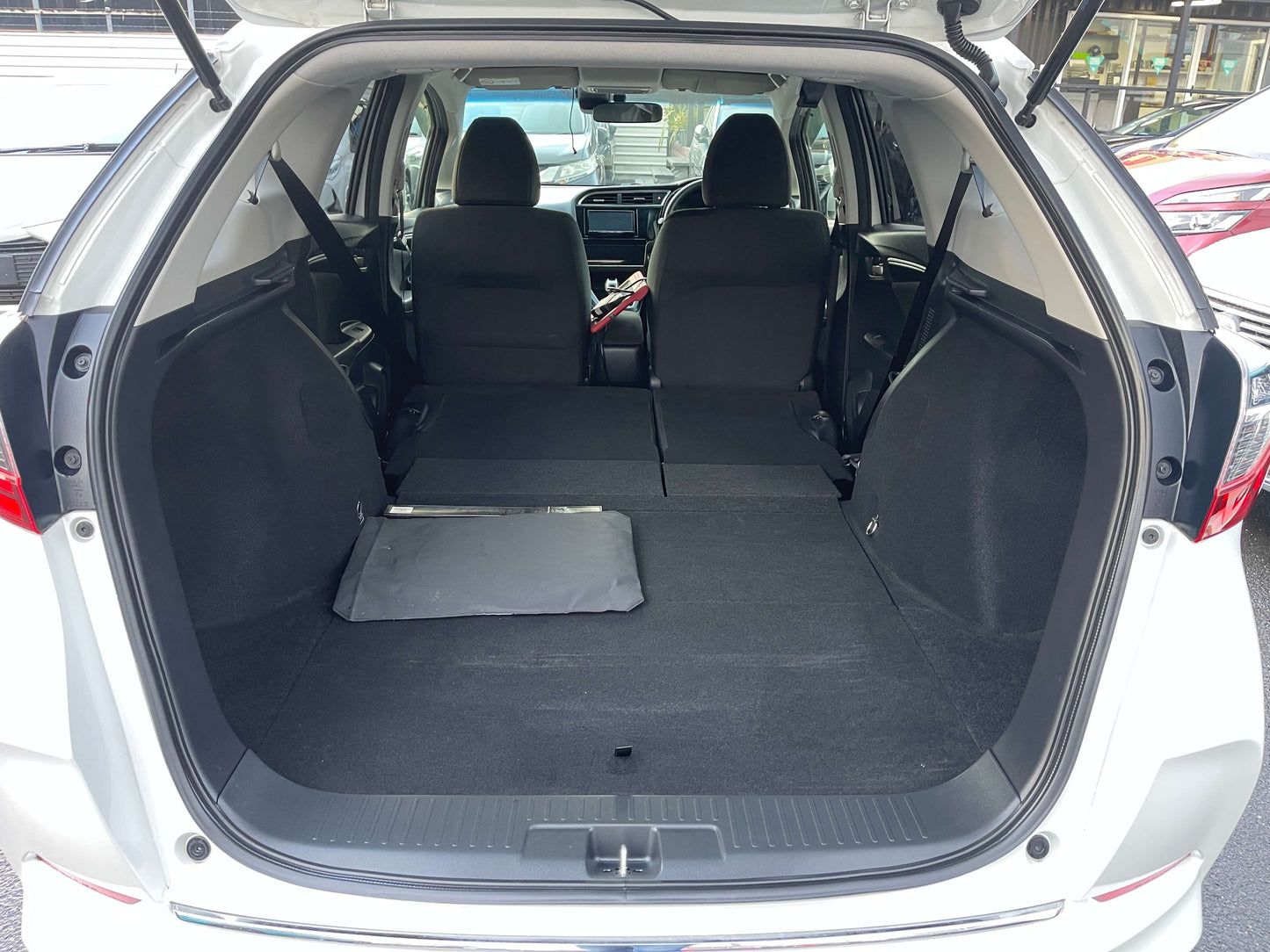 Interior view of the spacious trunk area in a 2021 Honda Shuttle Hybrid X Honda Sensing Edition.
