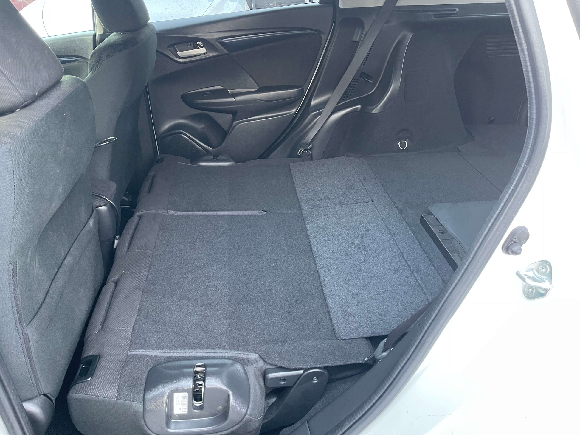 Interior view of the rear seating area with the seats folded down in the 2021 Honda Shuttle Hybrid X Honda Sensing Edition.
