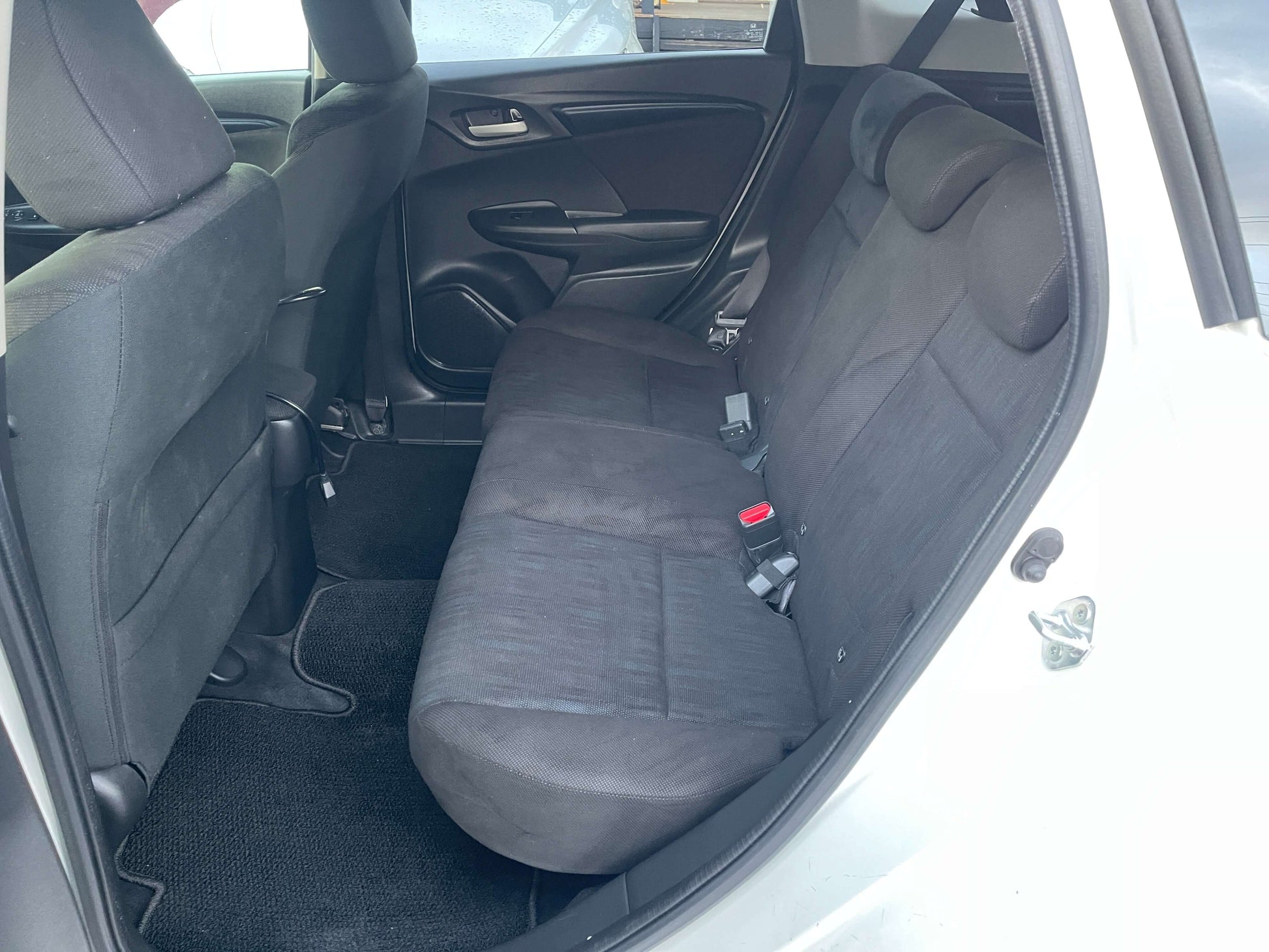 Interior view of the back seat of a 2021 Honda Shuttle Hybrid X, spacious seating for five passengers.