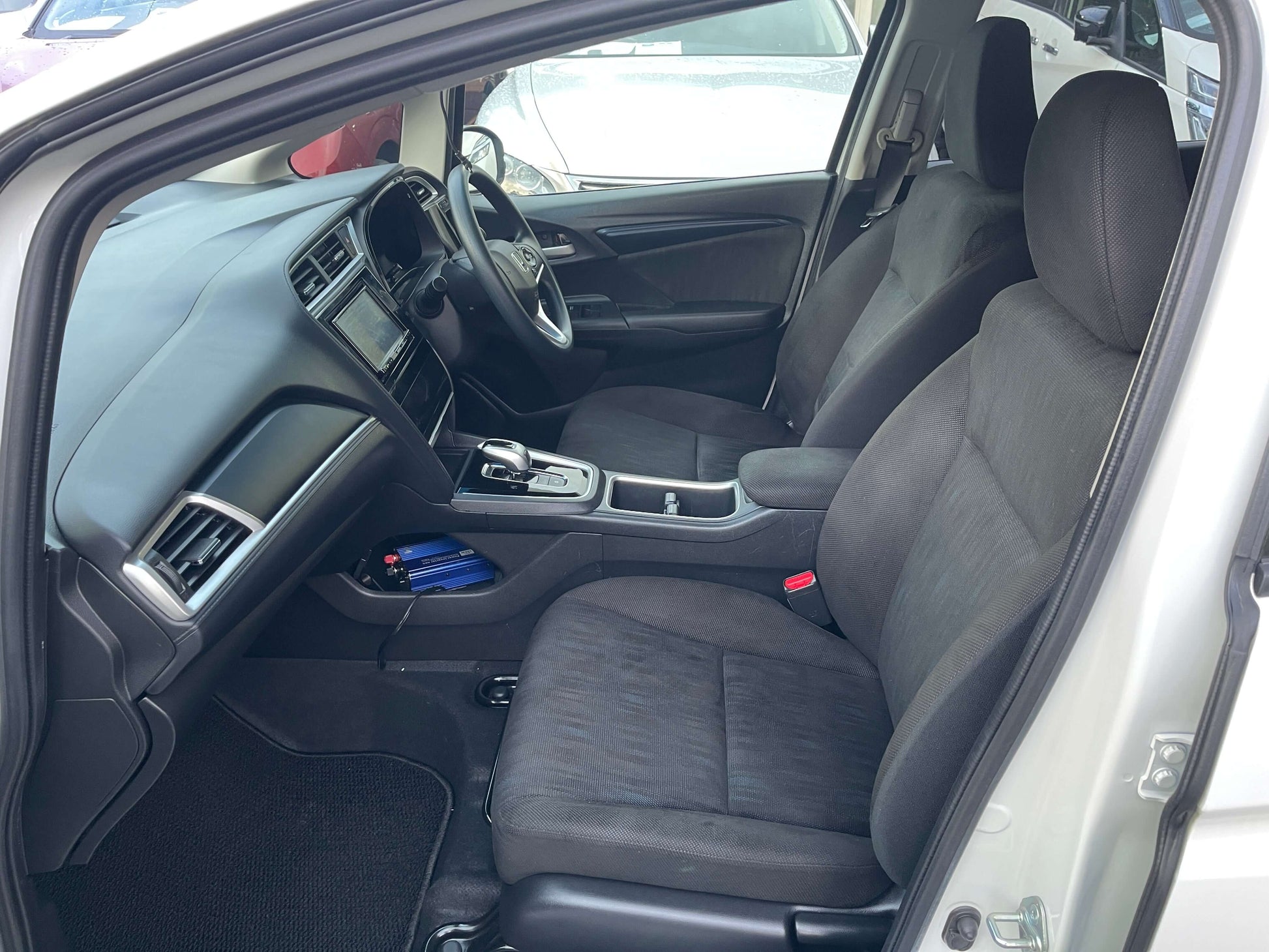 2021 Honda Shuttle Hybrid X Honda Sensing Edition interior view showcasing comfortable seating and modern dashboard.