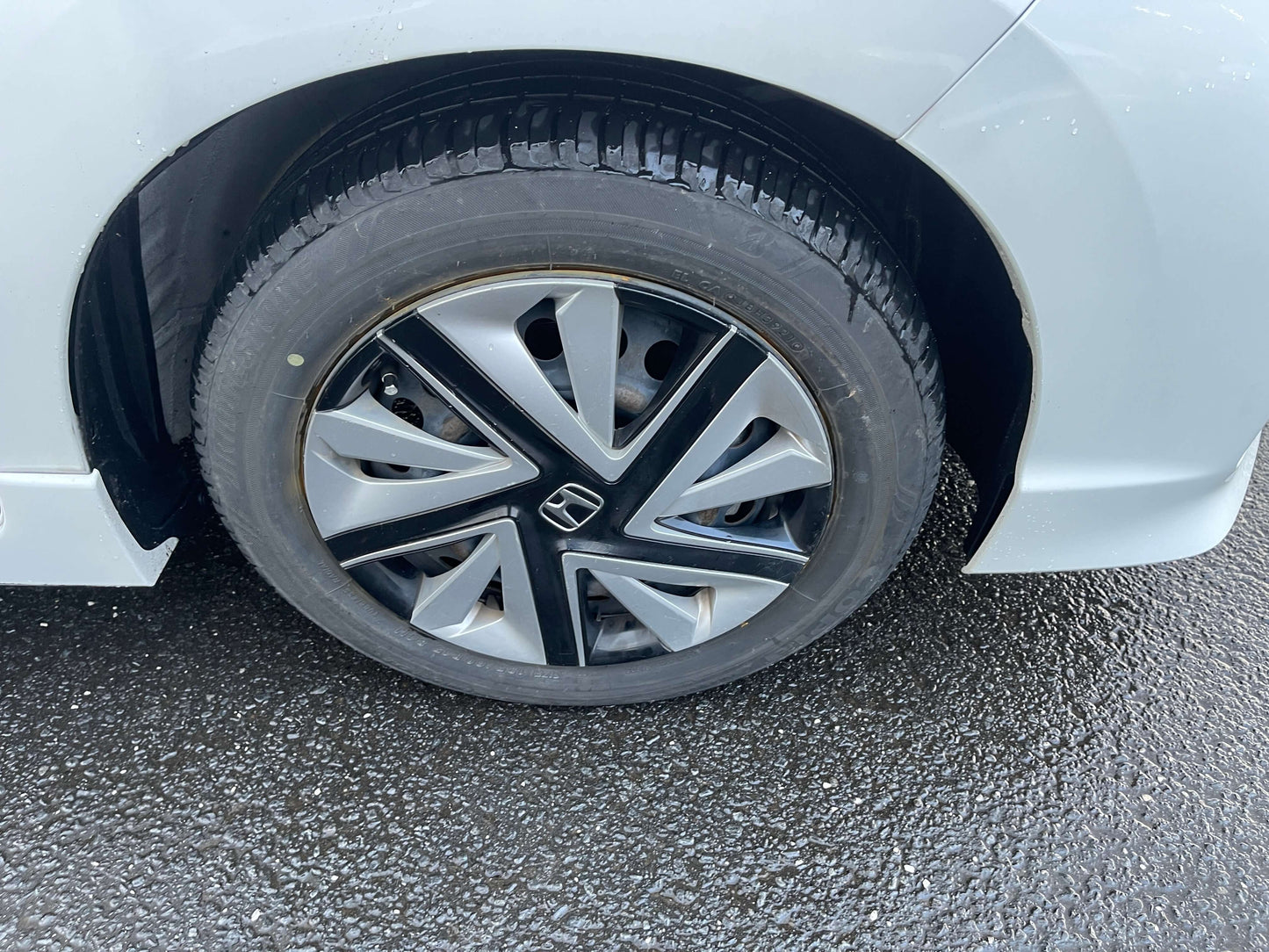 Close-up of the alloy wheel on a 2021 Honda Shuttle Hybrid X Honda Sensing Edition, showcasing the unique design.