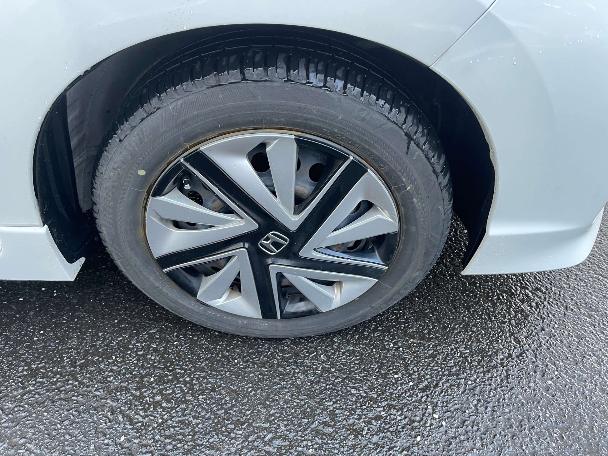 Close-up of the alloy wheel on a 2021 Honda Shuttle Hybrid X Honda Sensing Edition, showcasing the unique design.