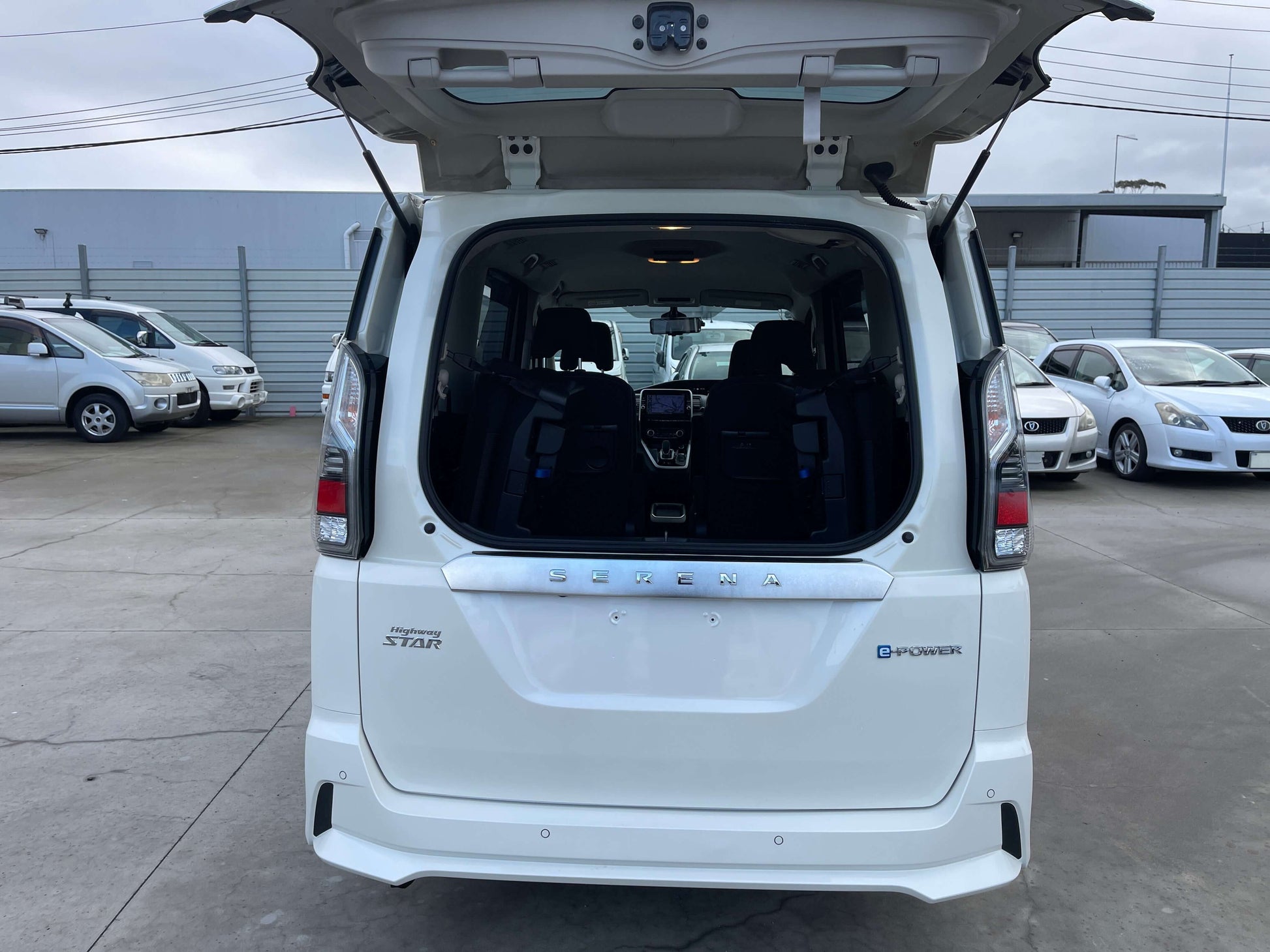 Rear view of 2018 Nissan Serena 1.2 e-Power Highway Star V with open trunk, showcasing spacious interior.