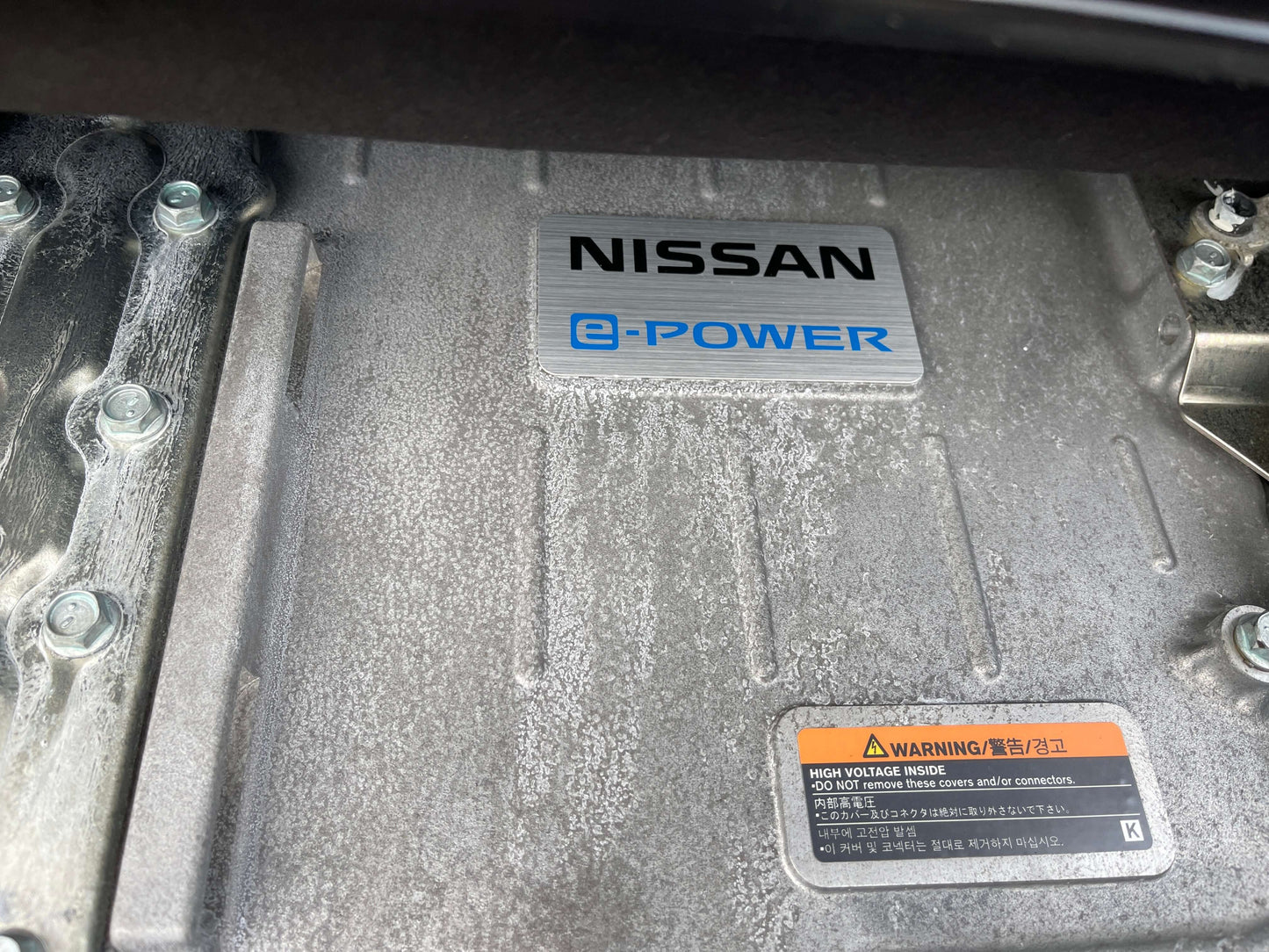 2018 Nissan Serena 1.2 e-Power Nissan e-Power engine component visible under the hood of a vehicle, highlighting innovative technology.