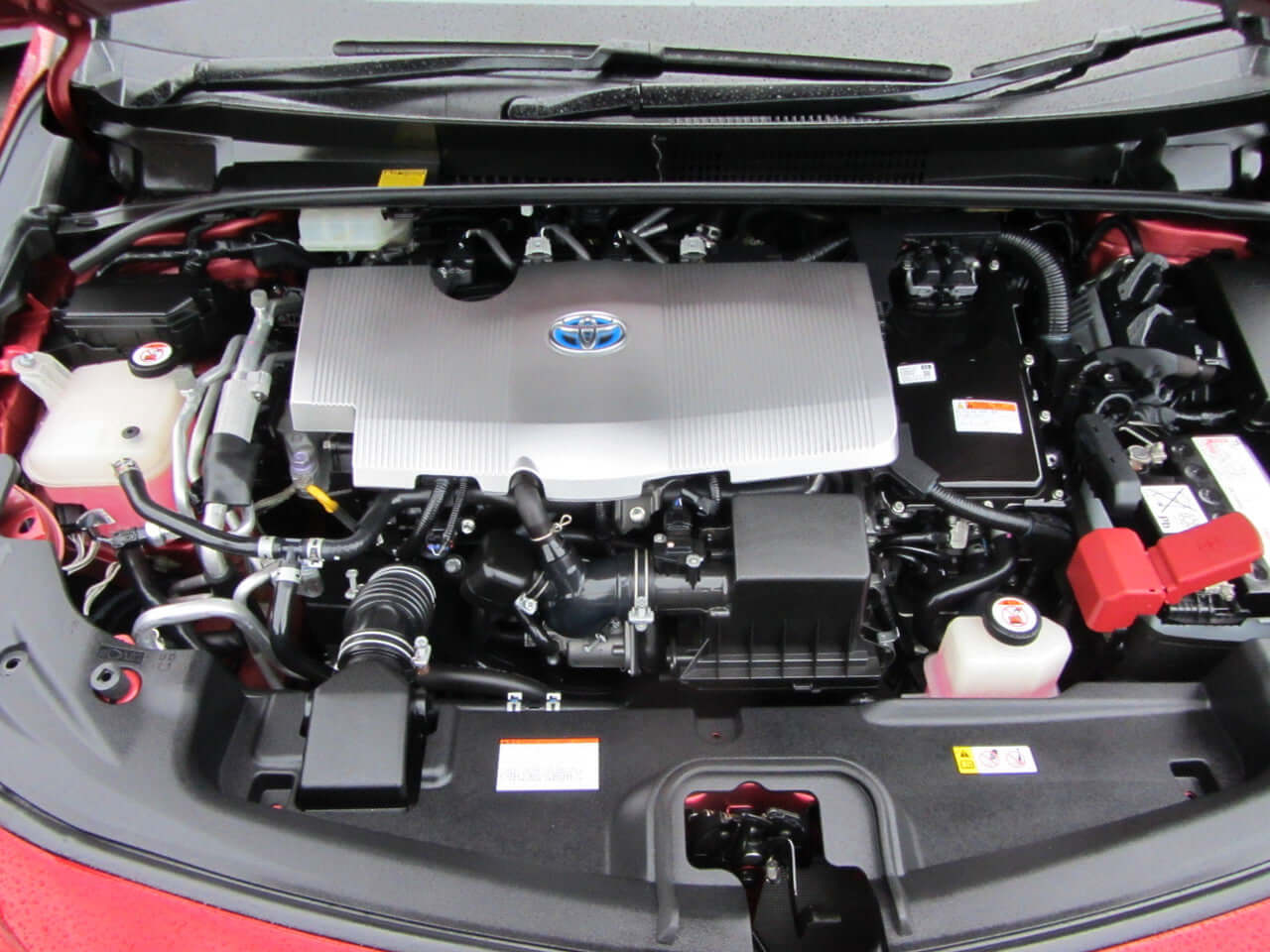 Engine compartment of 2017 Toyota Prius Prime Plug-In Hybrid 1.8L G-Edition showcasing hybrid technology.