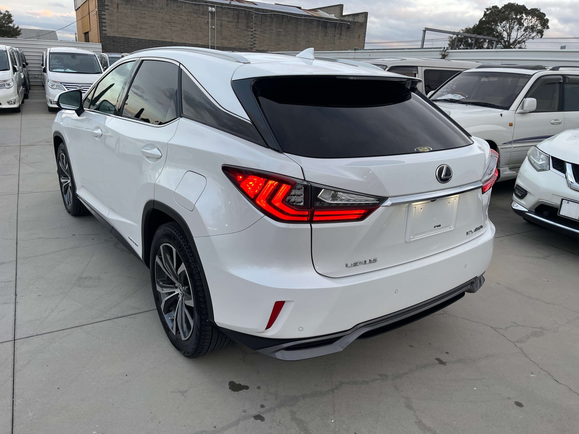 2017 Lexus RX450H V6 3.5L Hybrid L Version luxury SUV rear view in white color, showcasing sleek design and modern features.