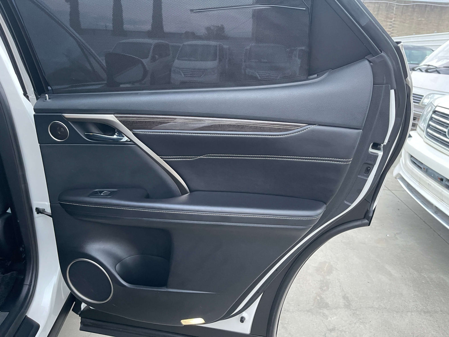 Interior view of the 2017 Lexus RX450H driver side door showcasing luxury details and finishes.