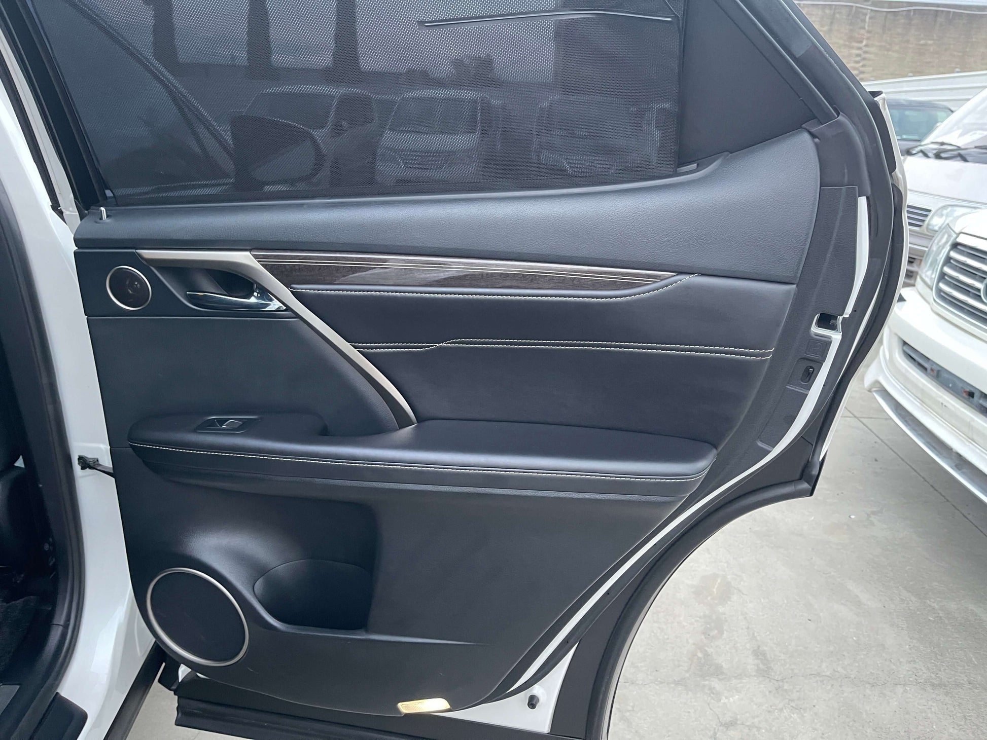 Interior view of the 2017 Lexus RX450H driver side door showcasing luxury details and finishes.