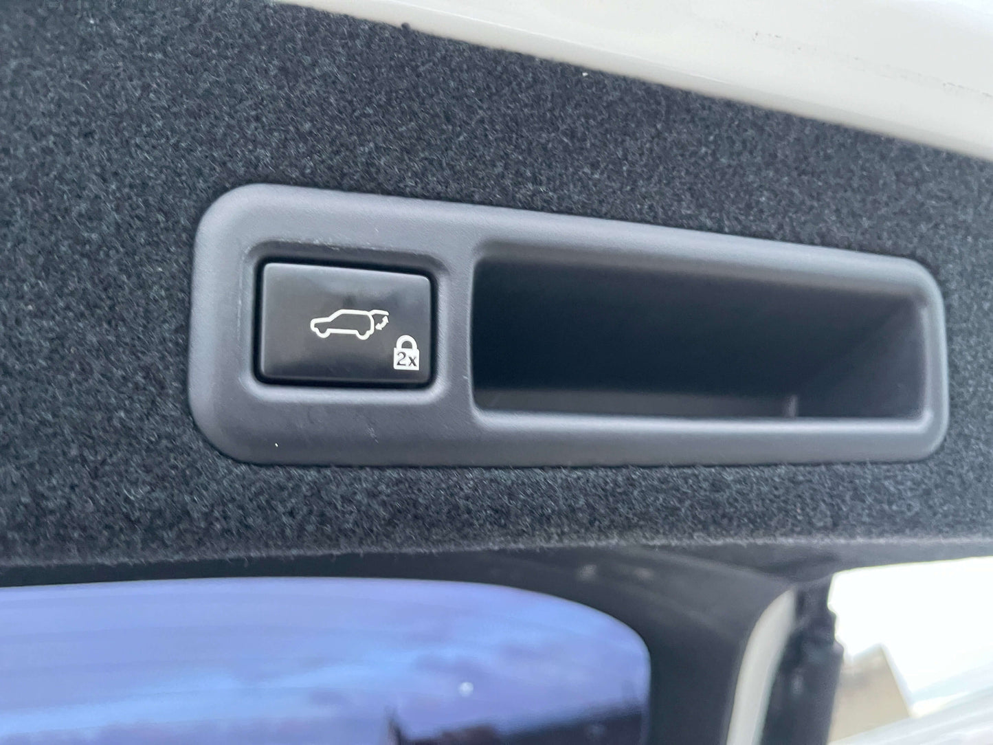 Interior button for hatchback release in a 2017 Lexus RX450H luxury SUV.