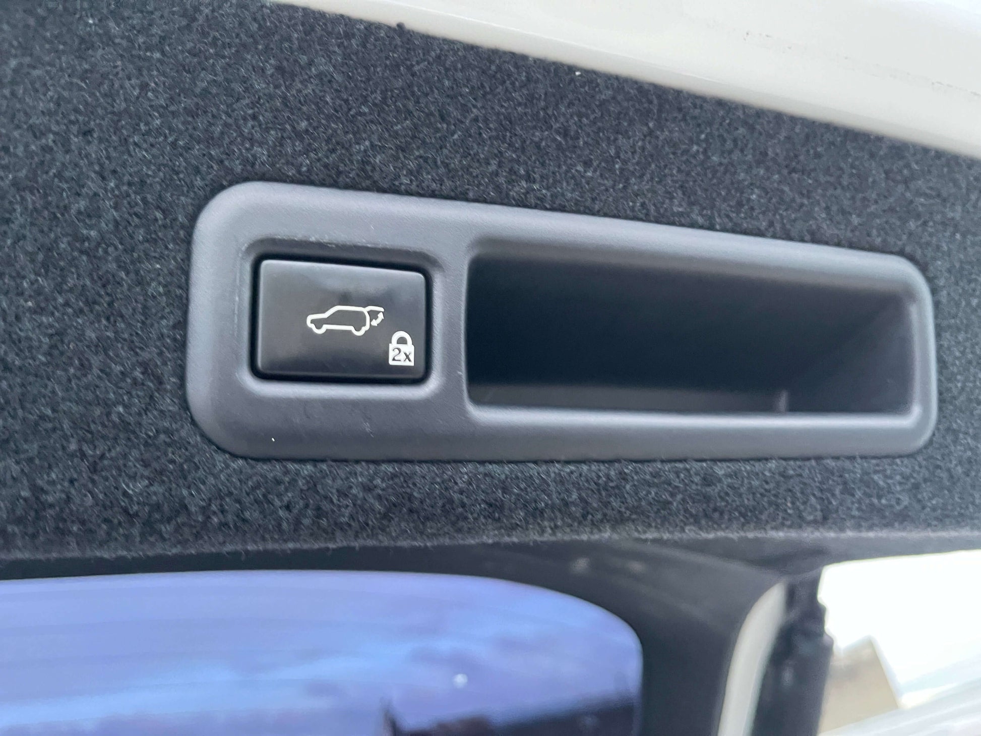 Interior button for hatchback release in a 2017 Lexus RX450H luxury SUV.