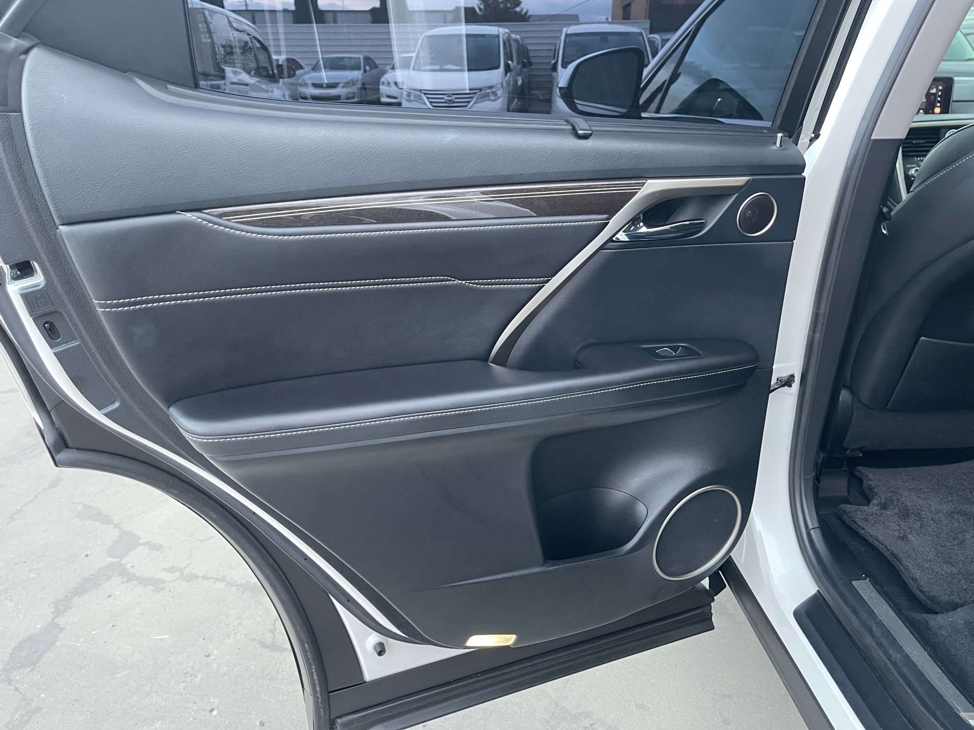 Interior door panel of a 2017 Lexus RX450H, showcasing luxury design and features.