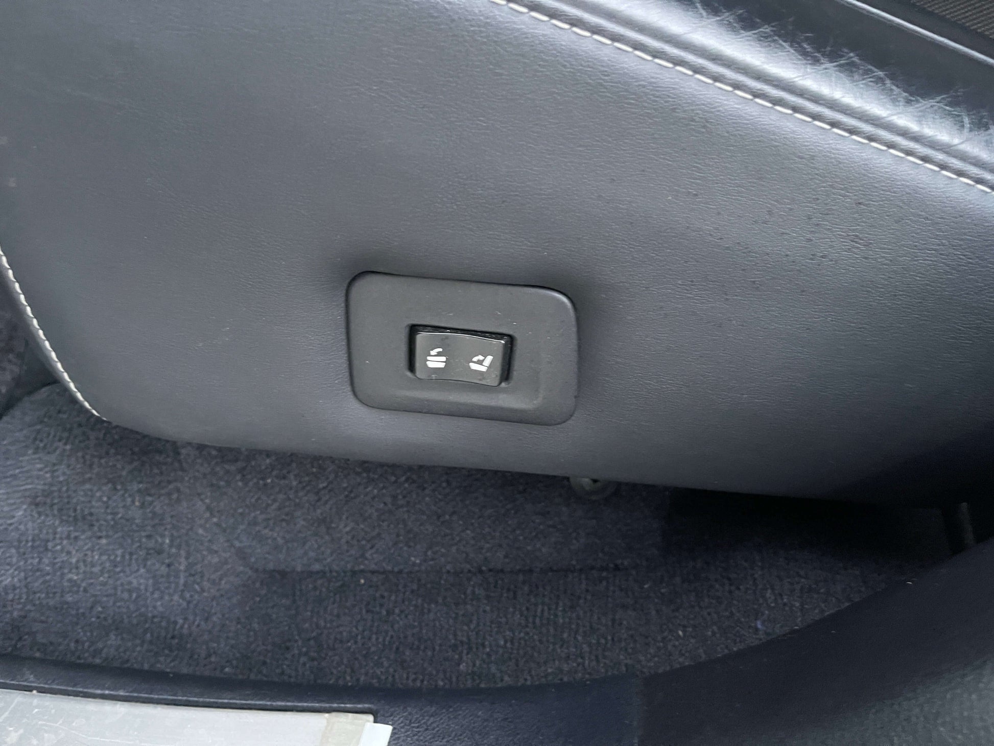 Button for seat adjustment in a 2017 Lexus RX450H hybrid luxury SUV interior.