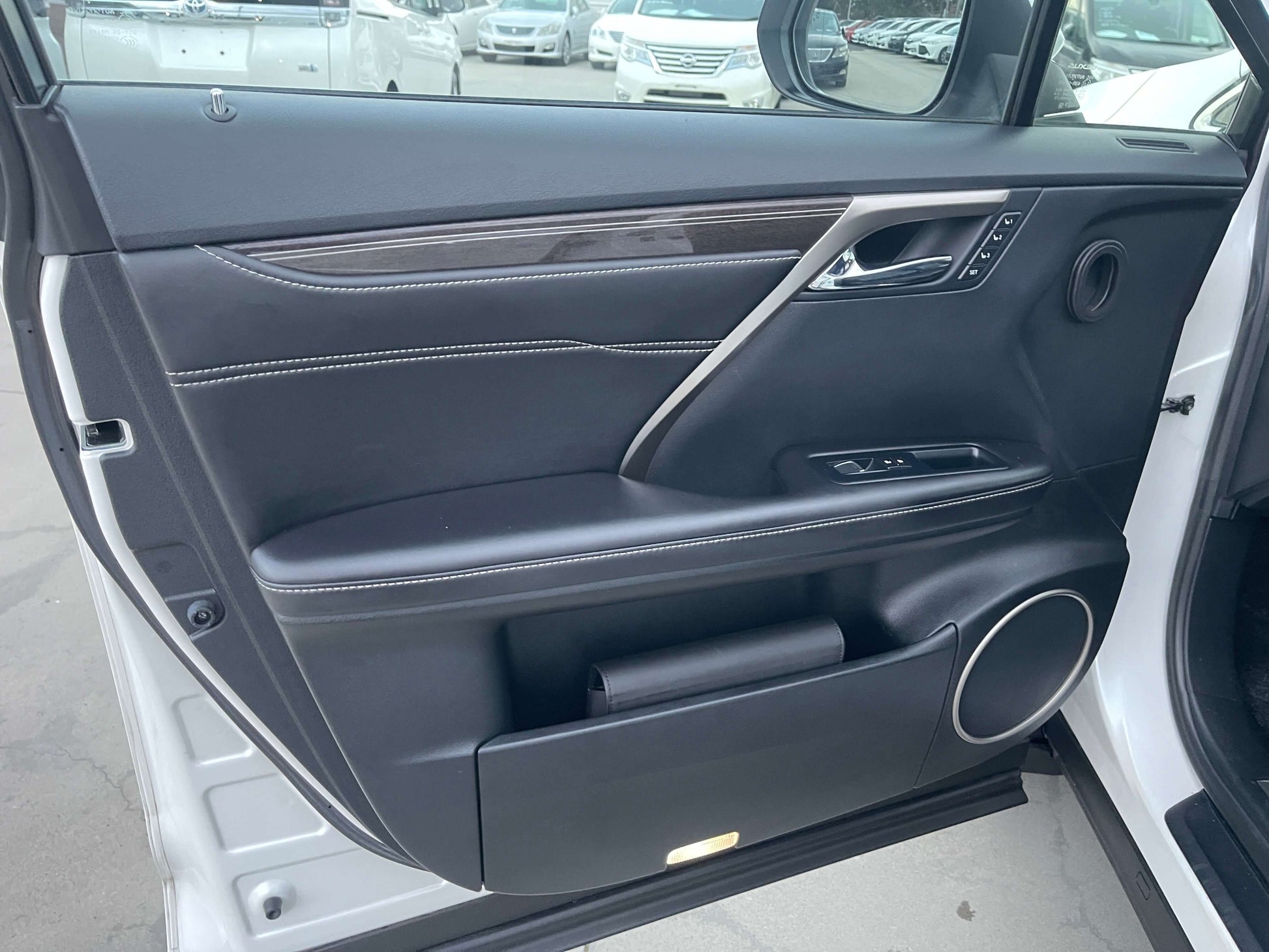 Interior door panel of a 2017 Lexus RX450H luxury SUV, showcasing premium materials and craftsmanship.