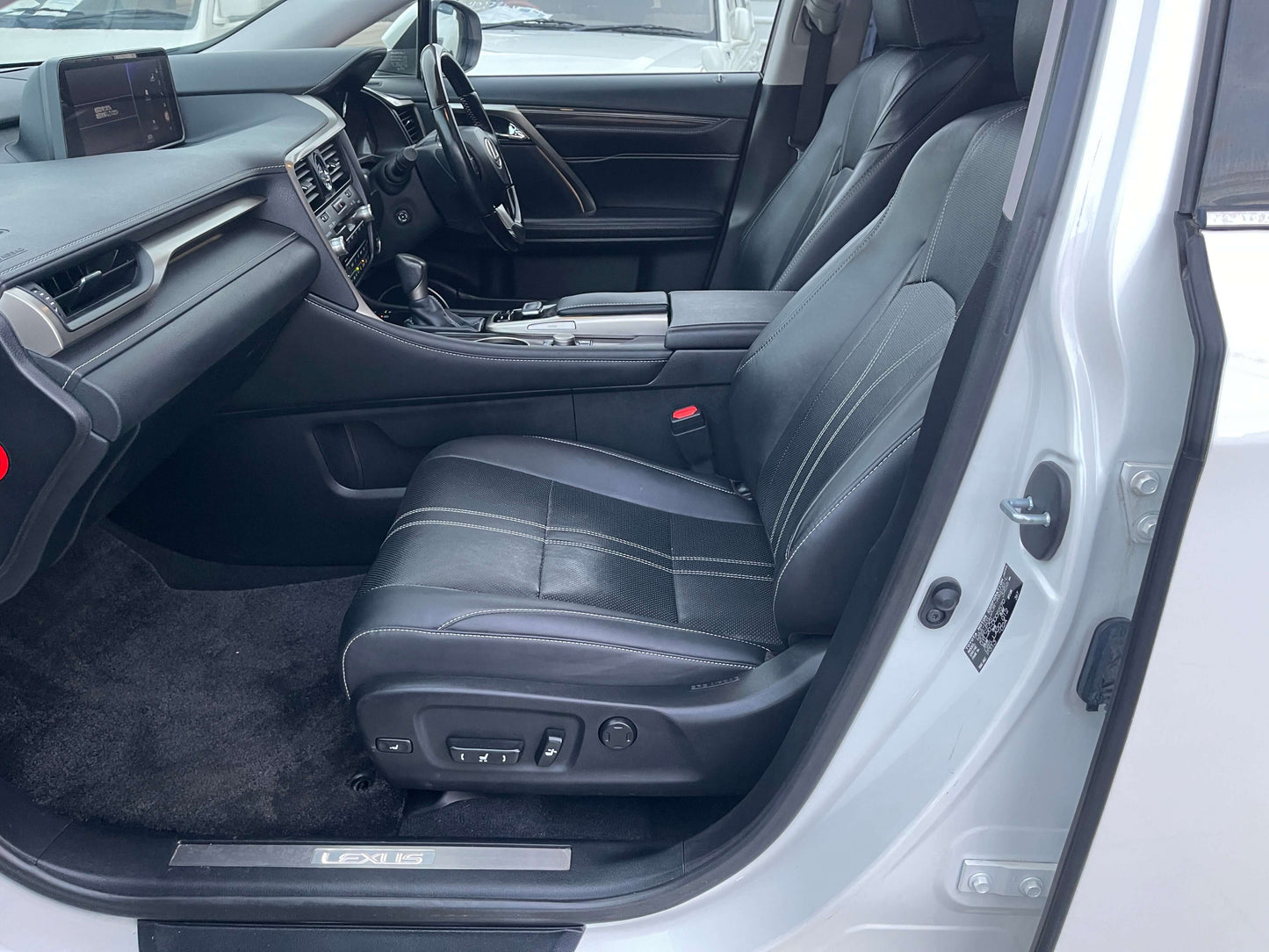 Interior view of 2017 Lexus RX450H showing spacious luxury seating and dashboard design.