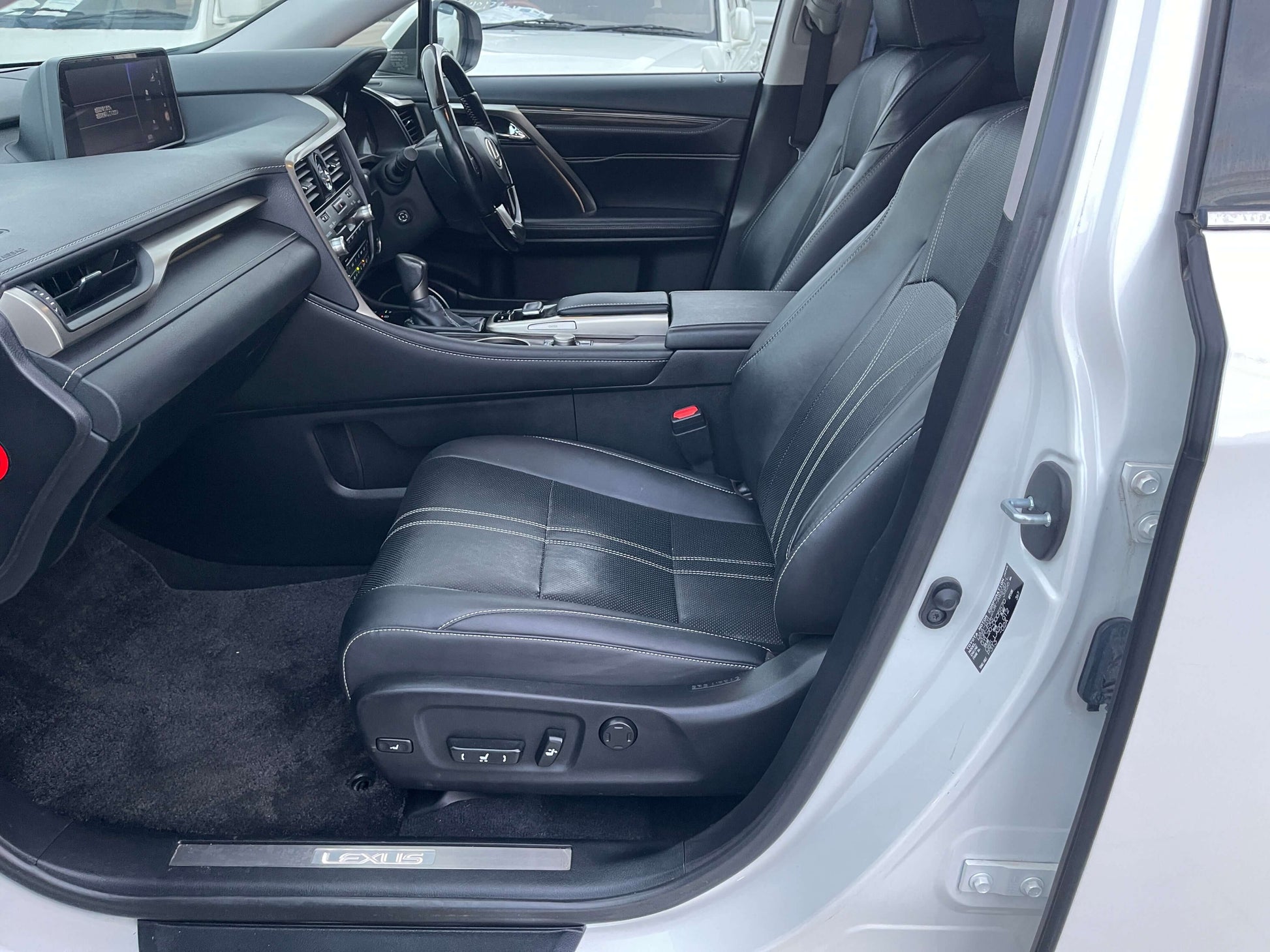 Interior view of 2017 Lexus RX450H showing spacious luxury seating and dashboard design.