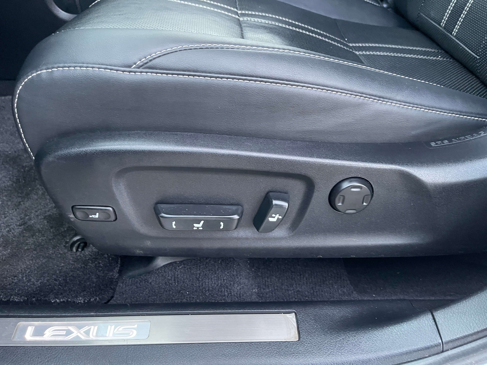 Close-up view of adjustable seat controls in a 2017 Lexus RX450H luxury SUV, highlighting ergonomic features.