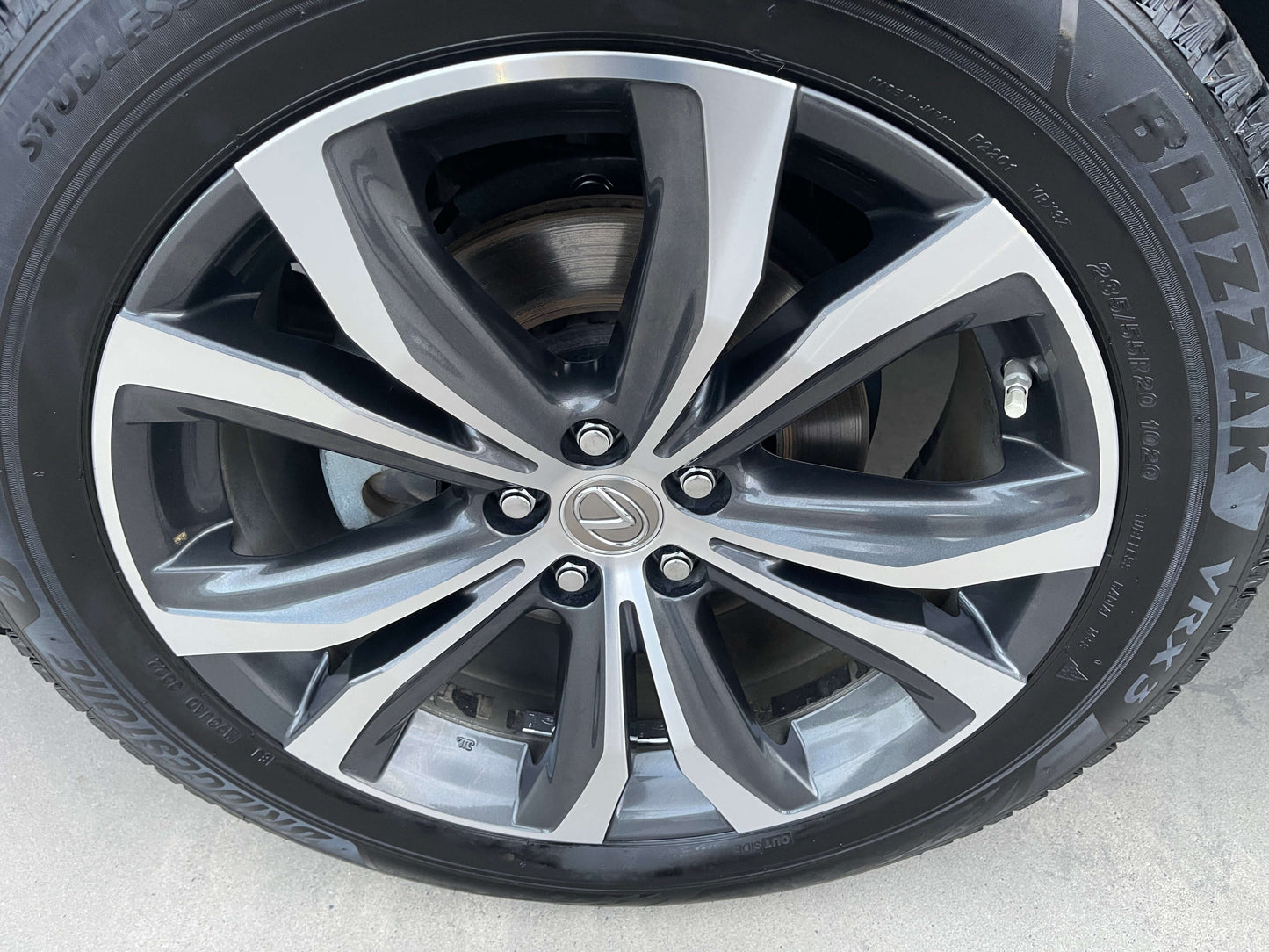 Close-up of a 2017 Lexus RX450H V6 hybrid SUV wheel showcasing sleek alloy design and tire details.