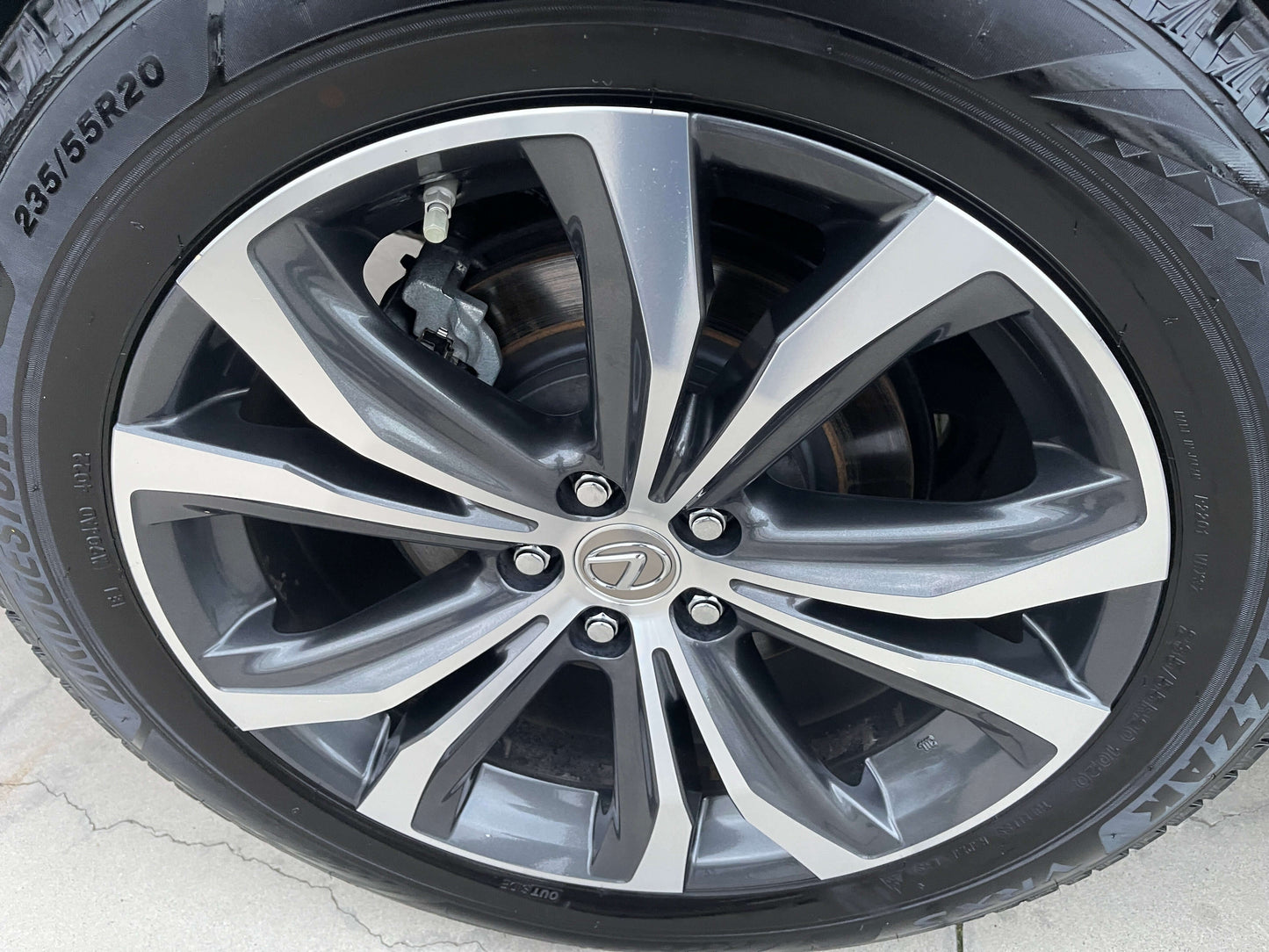 Close-up of a 2017 Lexus RX450H luxury SUV alloy wheel showcasing its sleek design and branding.