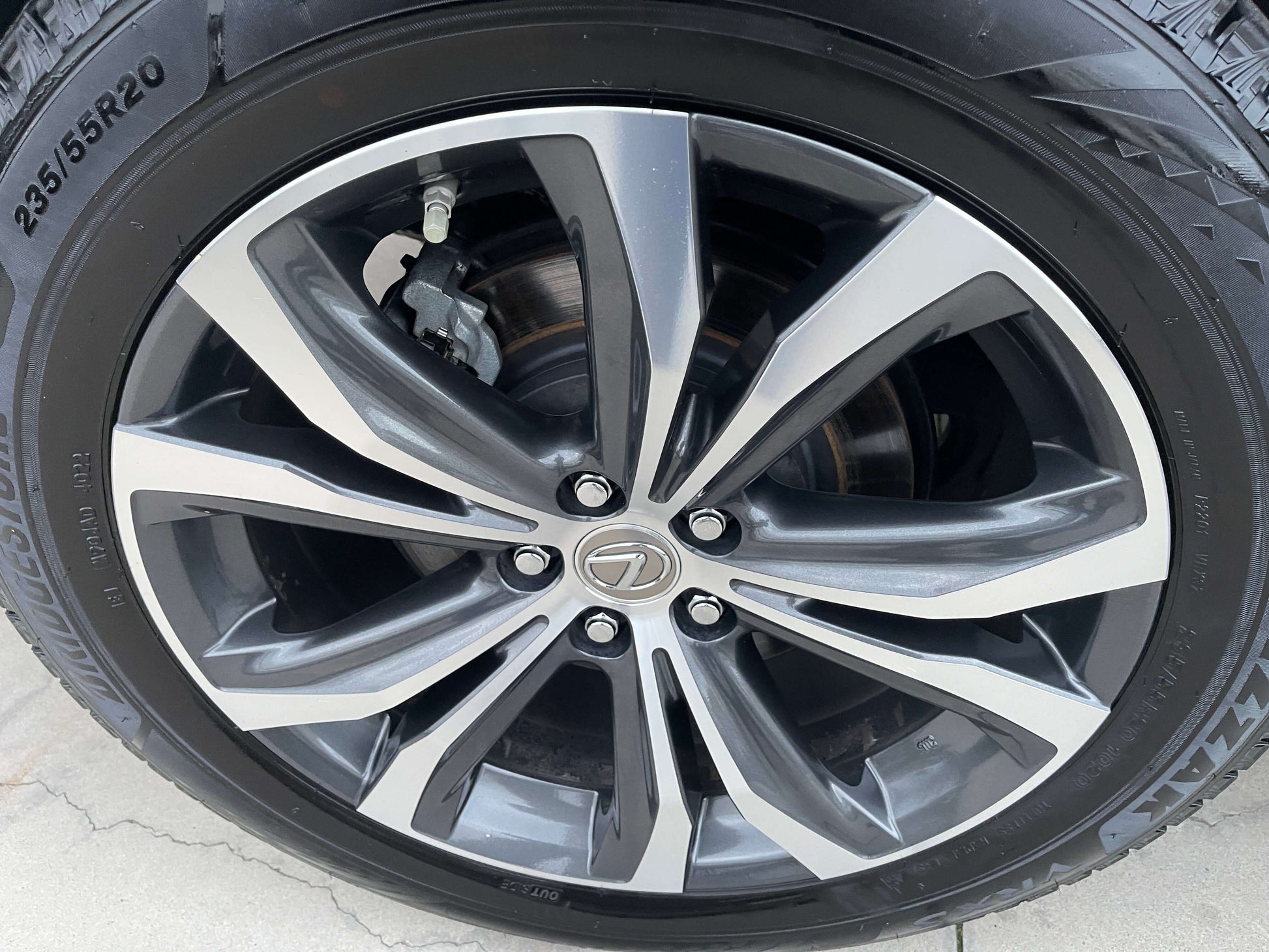 Close-up of a 2017 Lexus RX450H luxury SUV alloy wheel showcasing its sleek design and branding.