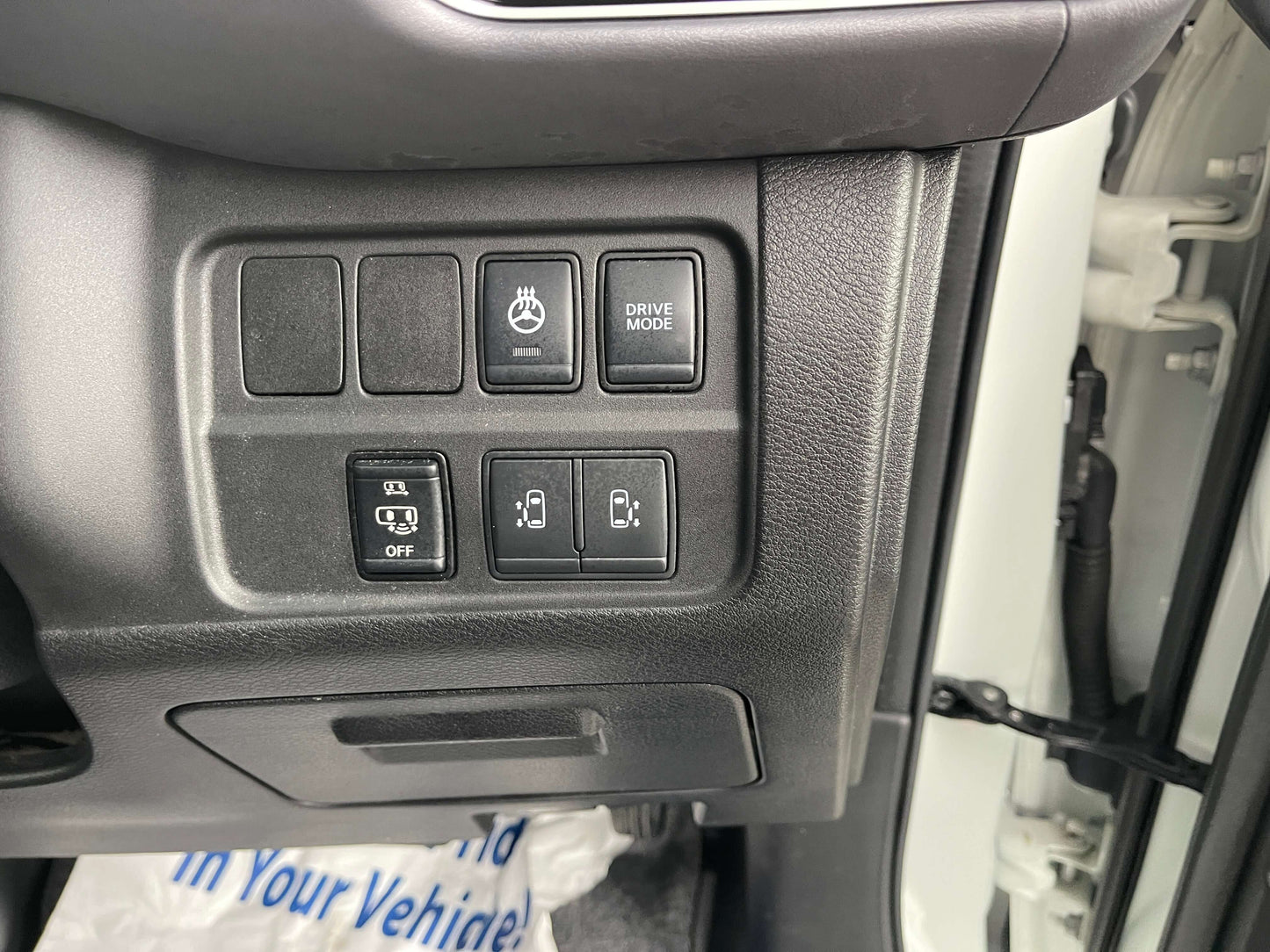 Control panel of 2020 Nissan Serena 1.2 e-Power with buttons for drive mode and various vehicle settings.