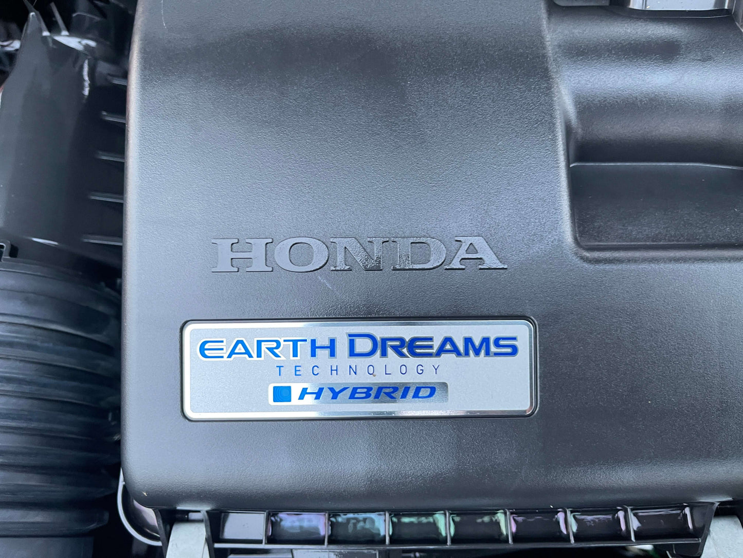 2020 Honda Fit 1.5 e:HEV engine cover showcasing Honda Earth Dreams Technology Hybrid.