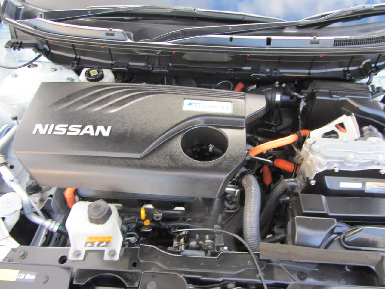 Engine compartment of 2015 Nissan X-Trail 2.0L 4WD Hybrid with Emergency Brake Package.