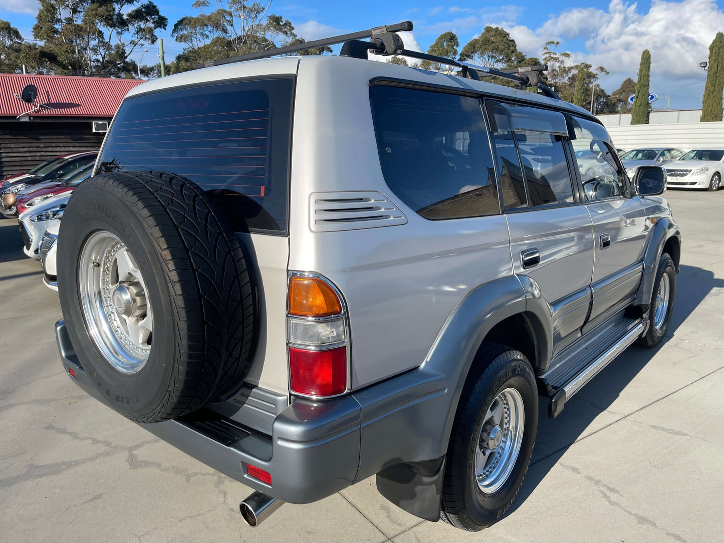1996 Toyota Land Cruiser Prado V6 3.4L TZ silver exterior rear view with spare tire.